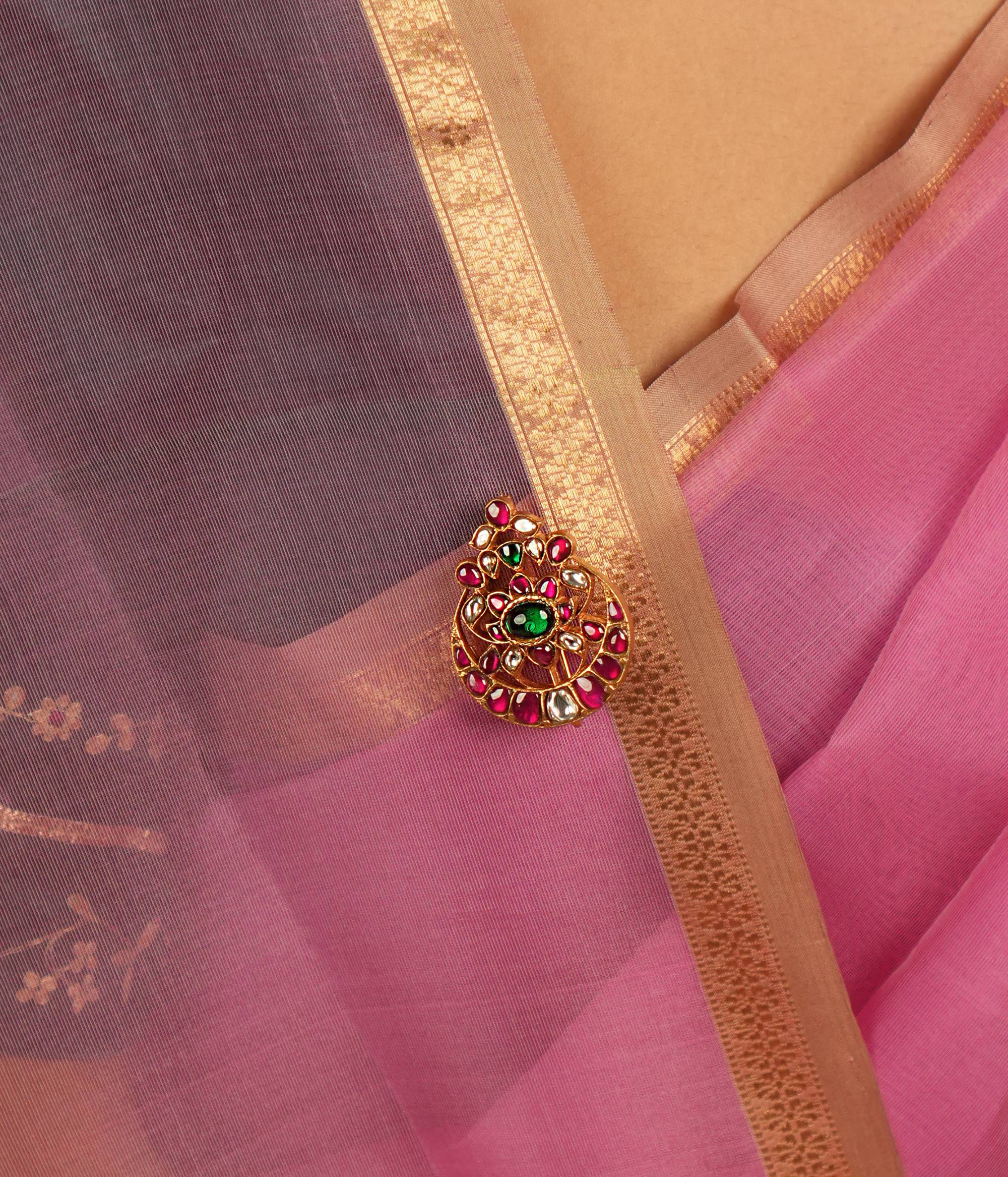 This brooch embodies elegance and heritage, adorned with green, red, and white Kundan stones, exuding timeless allure.