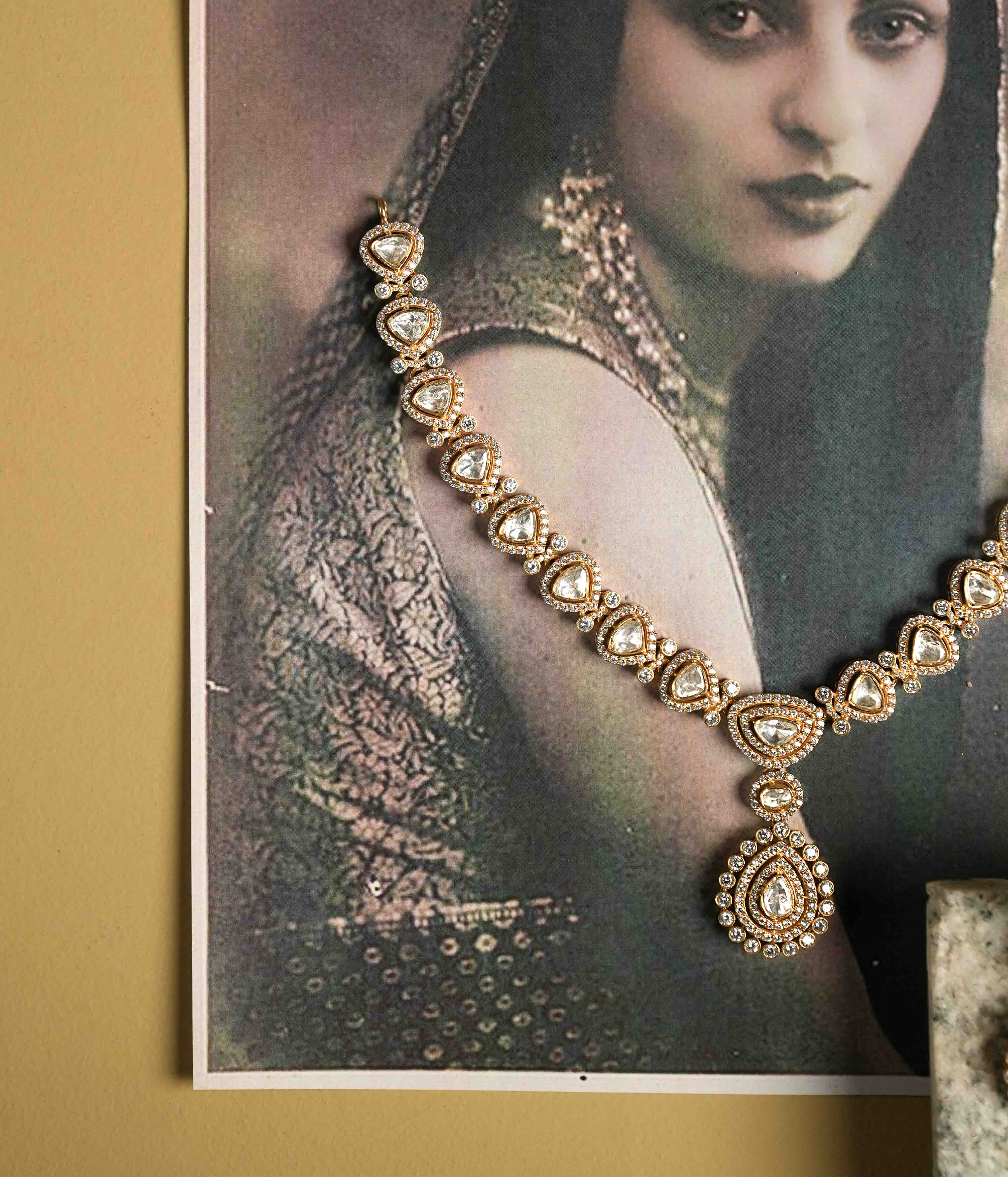 A choker crafted from handmade 92.5 sterling silver with 14ct gold plating, featuring moissanite polki stones and CZ stones, showcasing intricate floral motifs inspired by vintage Chettinad attigai design and embodying timeless elegance.