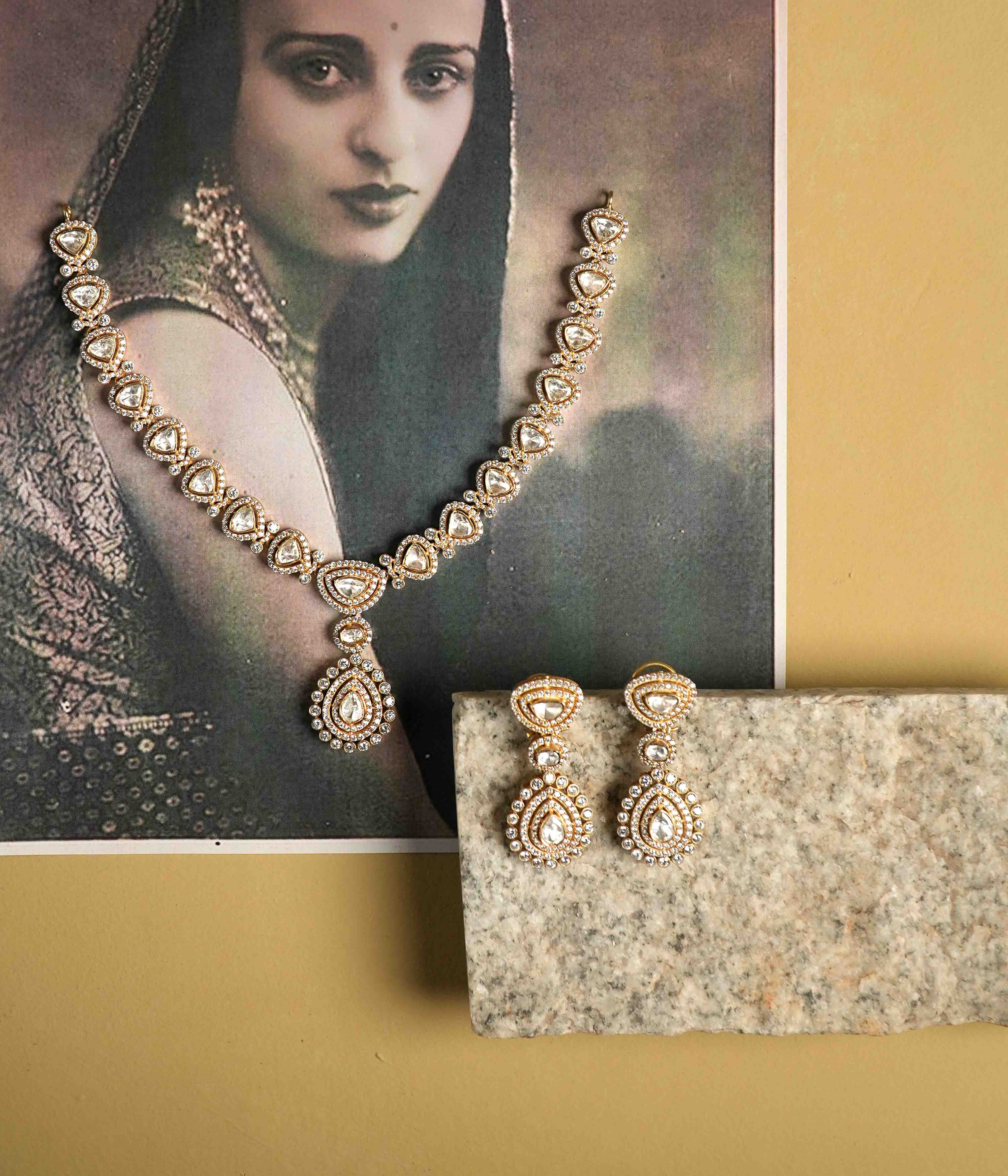 A choker crafted from handmade 92.5 sterling silver with 14ct gold plating, featuring moissanite polki stones and CZ stones, showcasing intricate floral motifs inspired by vintage Chettinad attigai design and embodying timeless elegance.