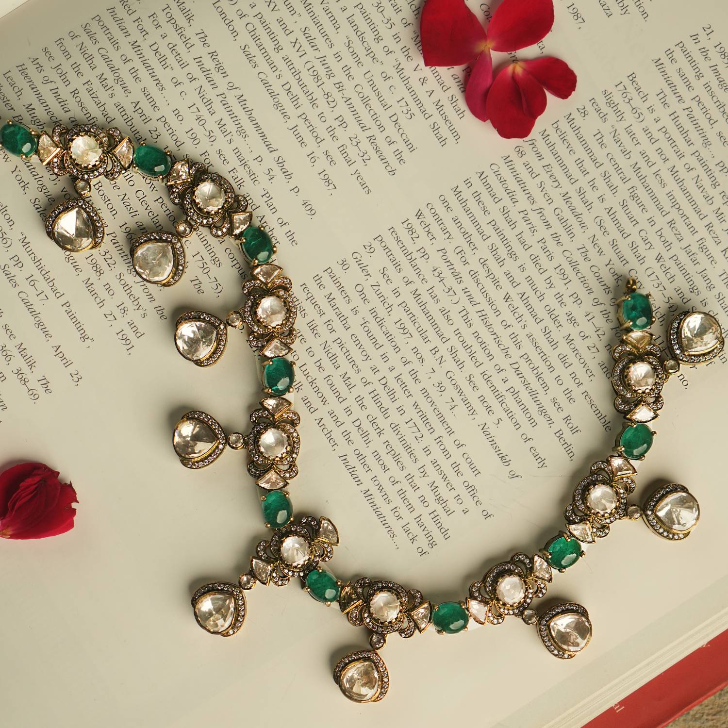 Embrace Victorian splendor with this exquisite Polki and moissanite necklace, adorned with emerald accents. Polki droplets framed by CZ stones exude timeless opulence and grace.