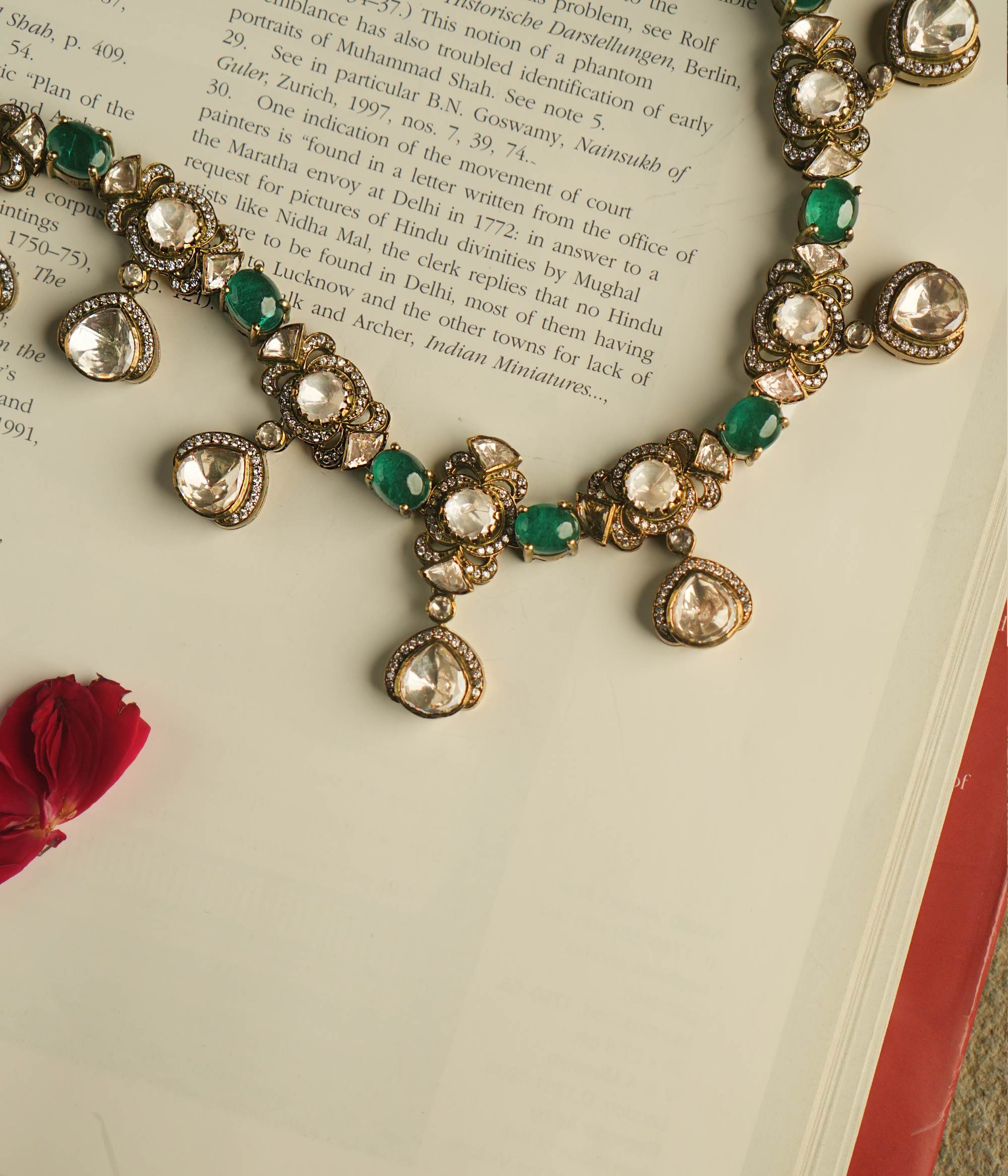 Embrace Victorian splendor with this exquisite Polki and moissanite necklace, adorned with emerald accents. Polki droplets framed by CZ stones exude timeless opulence and grace.