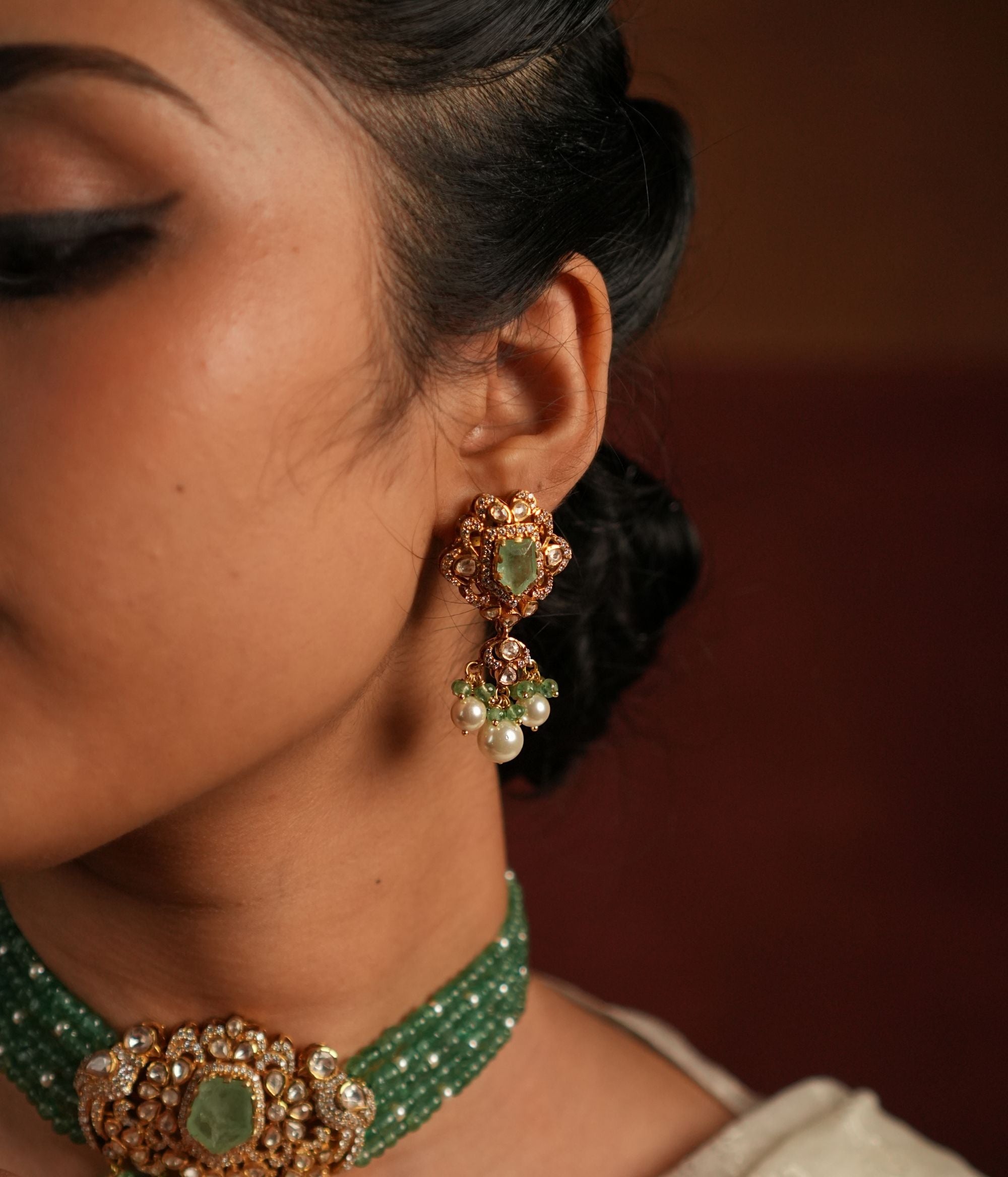 Elegant gold-plated silver drop earrings featuring Moissanite Polki Stones and Green Jade, exuding vintage charm with intricate filigree detailing. The Polki and Moissanite stones gracefully surround a vibrant green gemstone center, creating a timeless and sophisticated look.