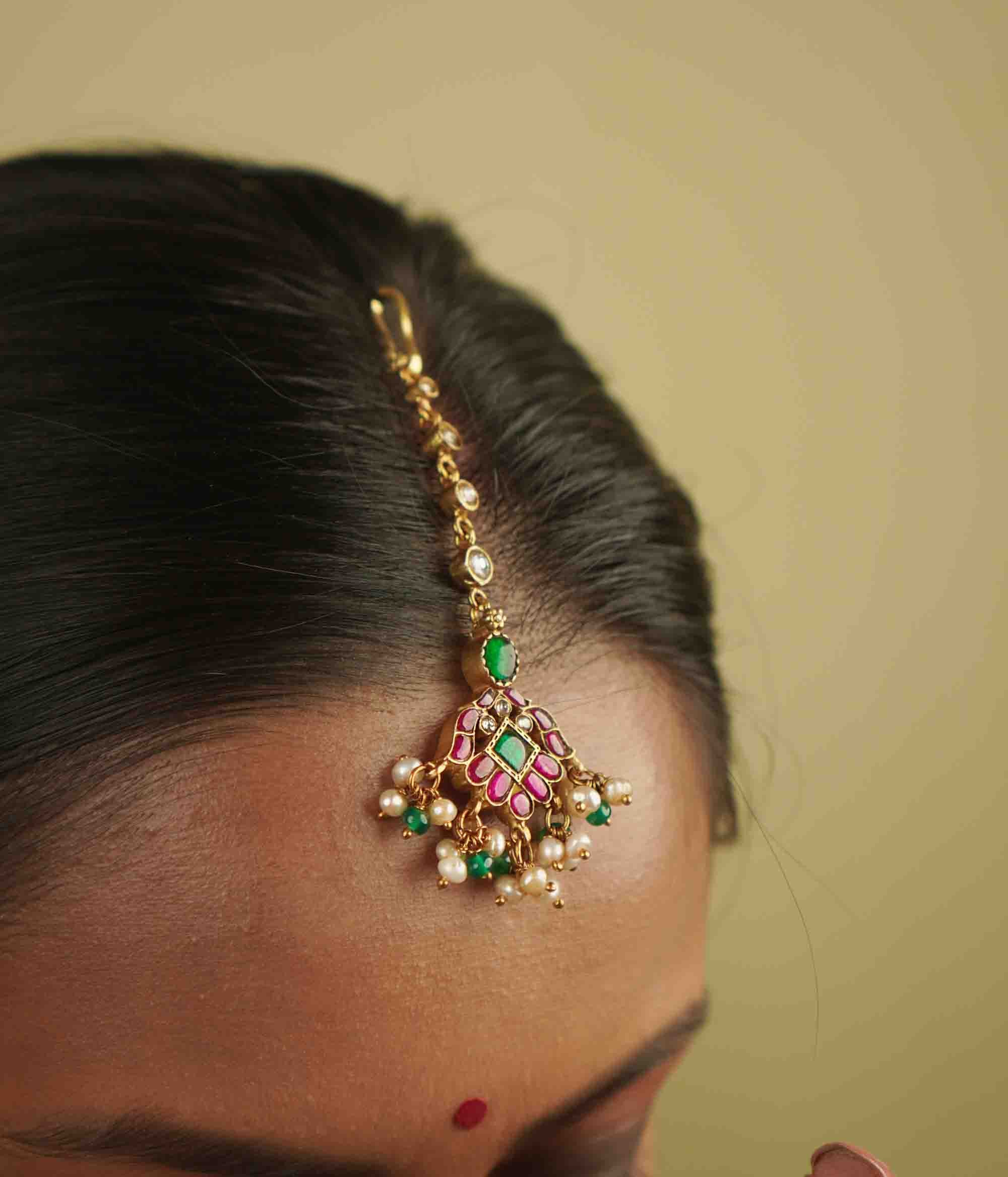 Traditional gold plated maangtika with red green and white kundan