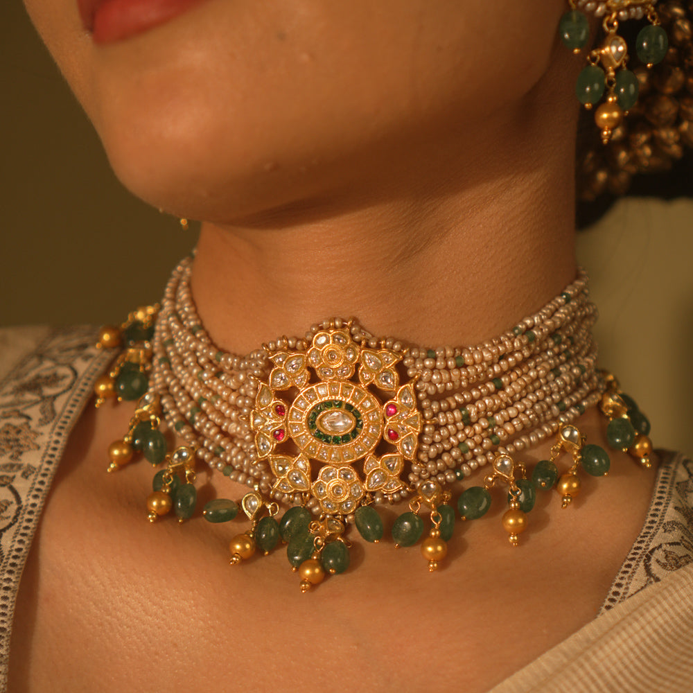 Heritage choker with temple medallion, rubies, emeralds, pearls and gold veiling—ancestral, elegant, and divine.