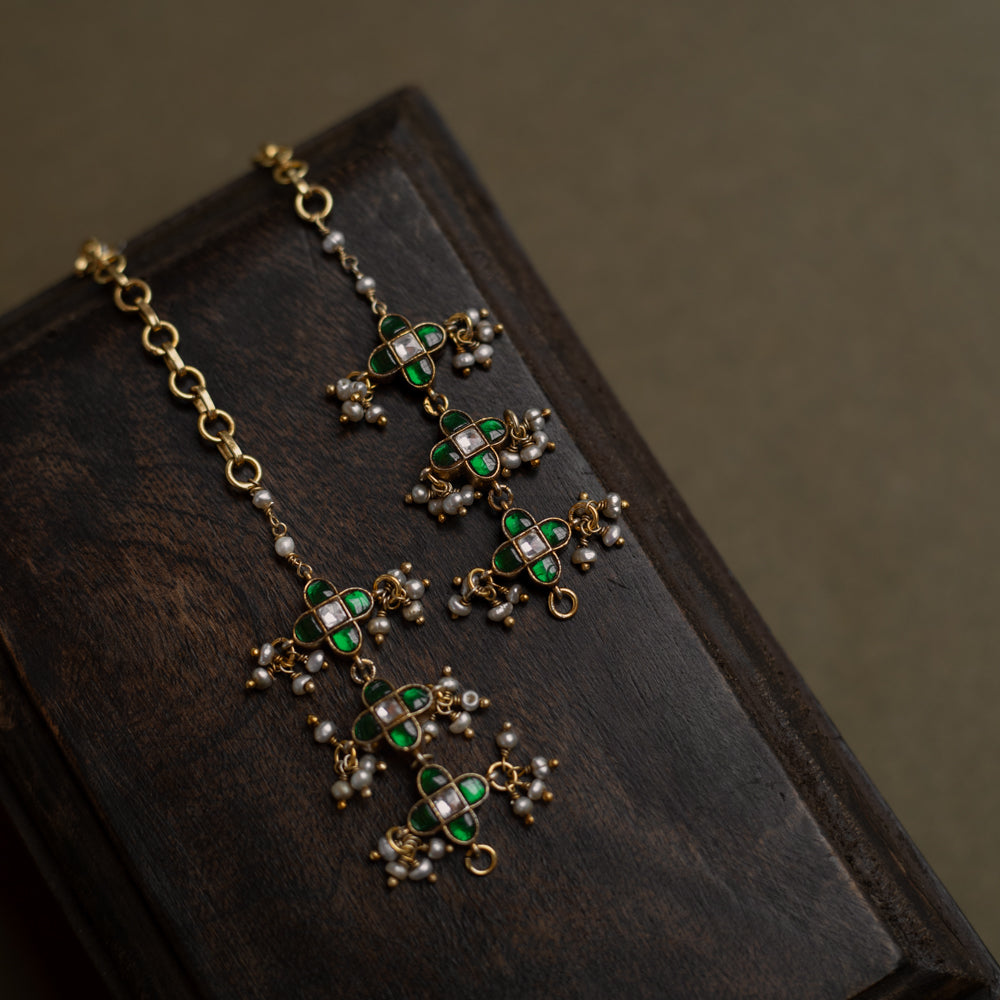Kundan Collection ear chain with green kundan, white kundan, and pearls in floral-inspired meadow design.