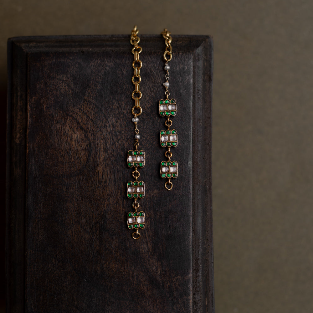 Kundan Collection ear chain with green kundan petals and white kundan stones in blooming vine design.