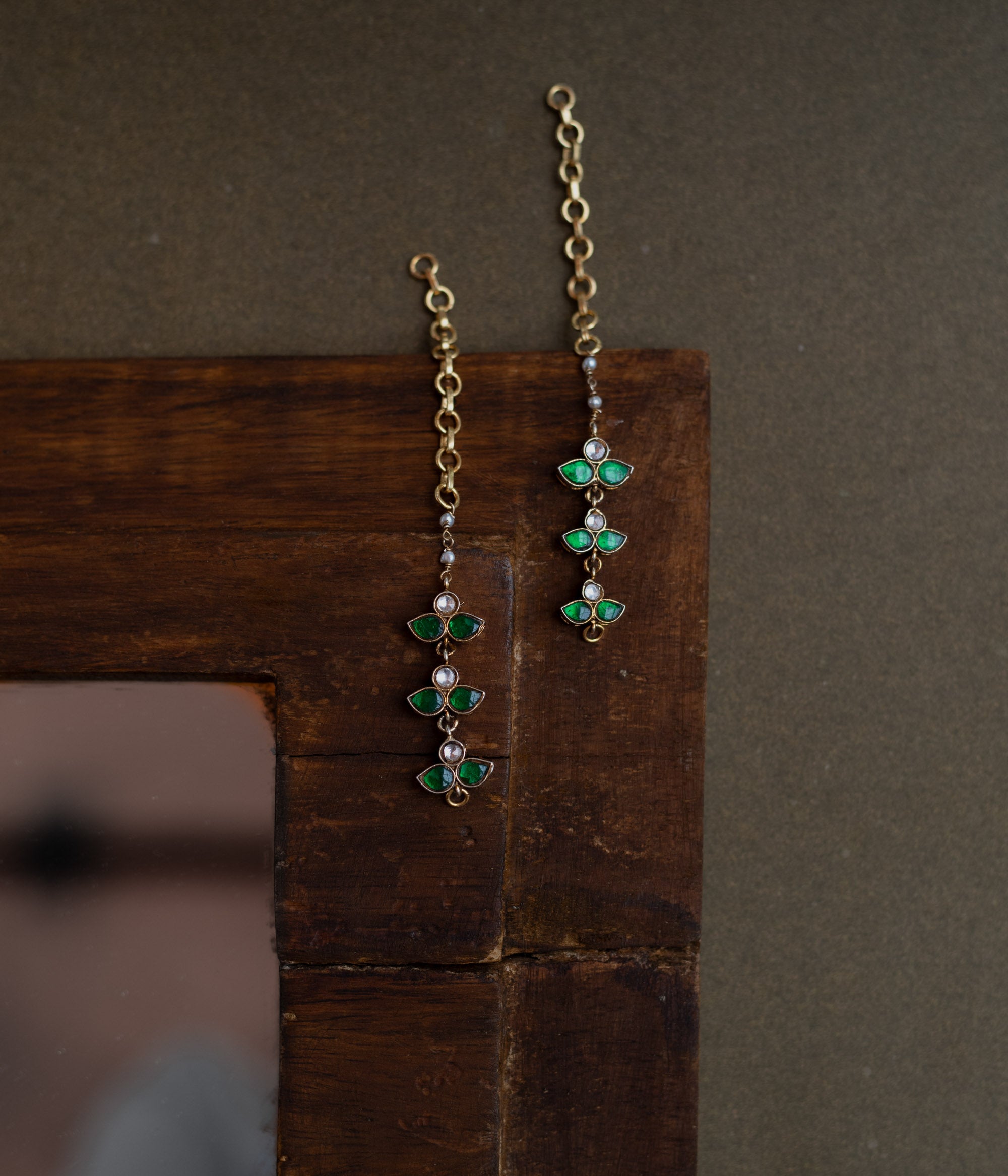 Kundan Collection ear chain with white and green kundan stones in a delicate floral design.