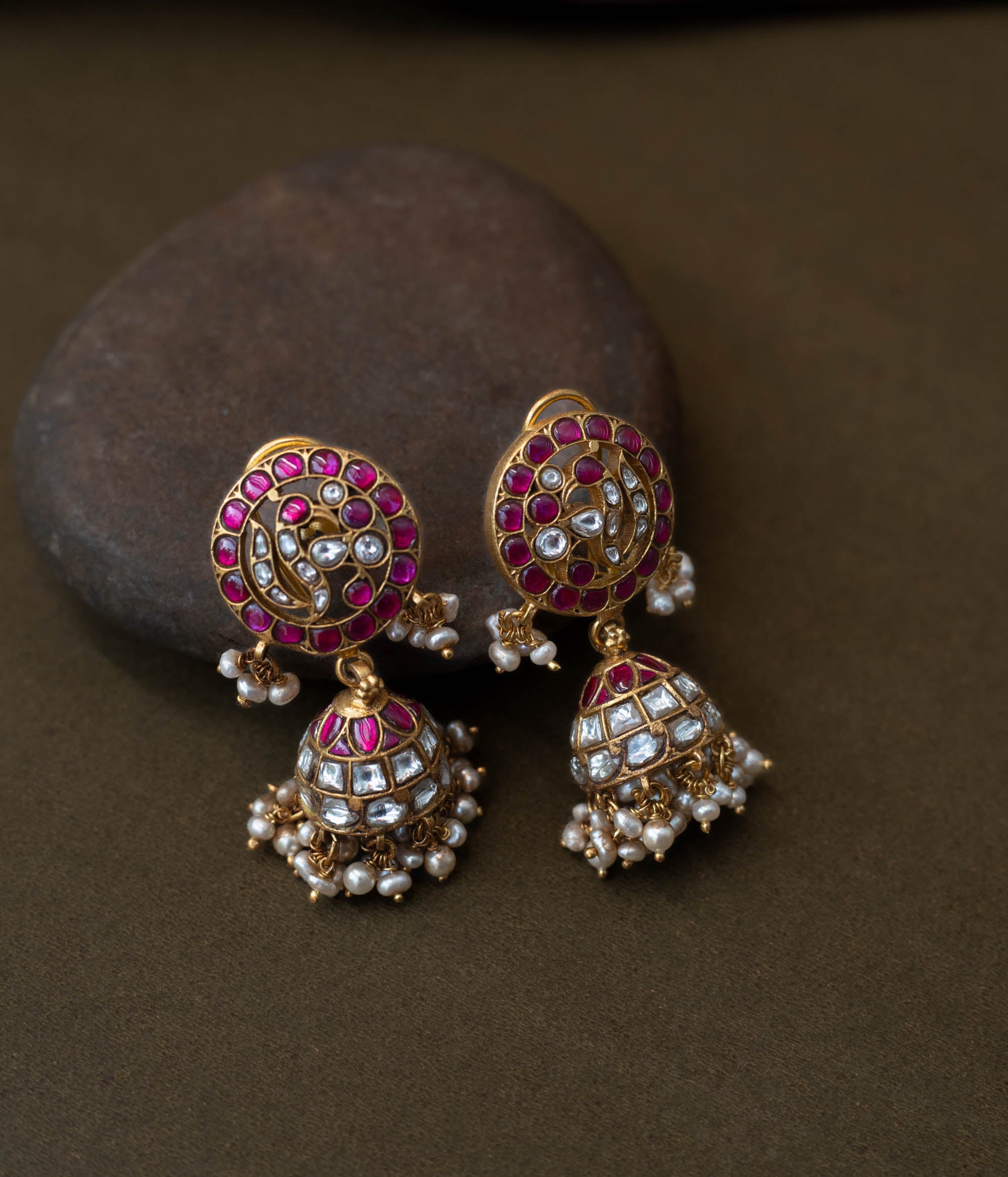 Vibrant Rang Mahal Jadau Earrings blending classic meenakari artistry with Kundan sparkle. Circular studs with ruby pink and mirror-polished white stones flow into dome-shaped jhumkas finished with delicate pearl hangings, perfect for weddings and festive occasions.