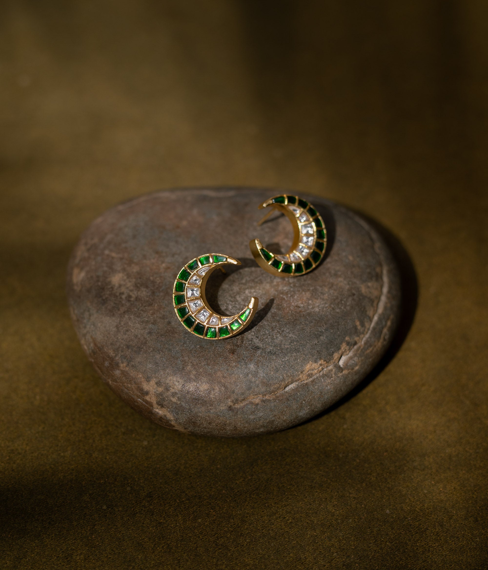 Floral earrings with a green Kundan center and white Kundan petals.