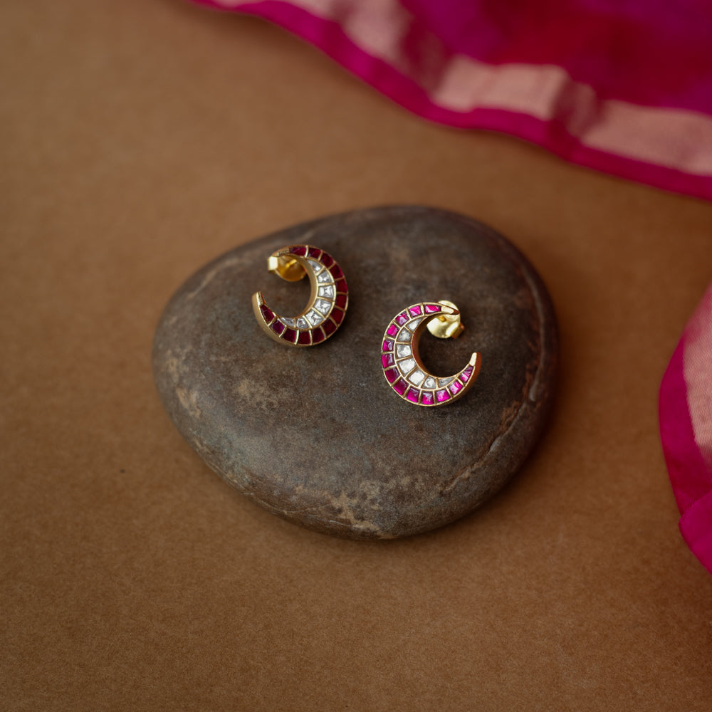 Gold crescent earrings adorned with red and white Kundan stones from Kundan Collection, exuding regal moonlit charm.