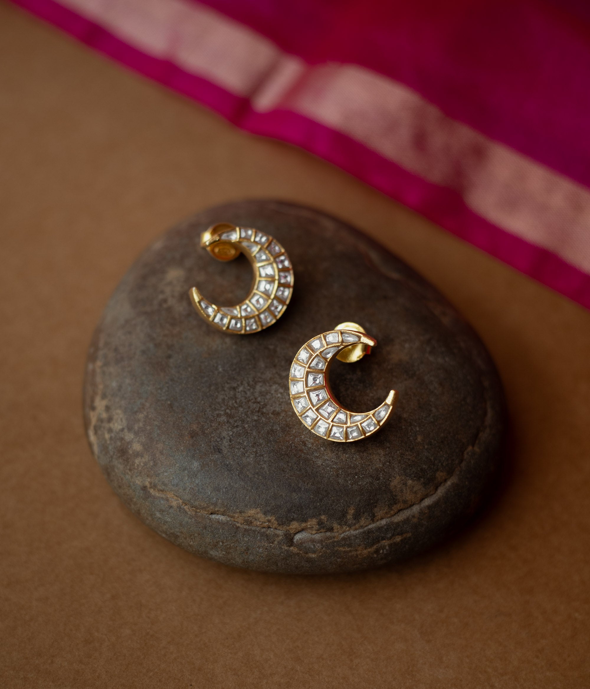 Gold crescent-shaped earrings studded with white Kundan stones from Kundan Collection, reflecting moonlight elegance.