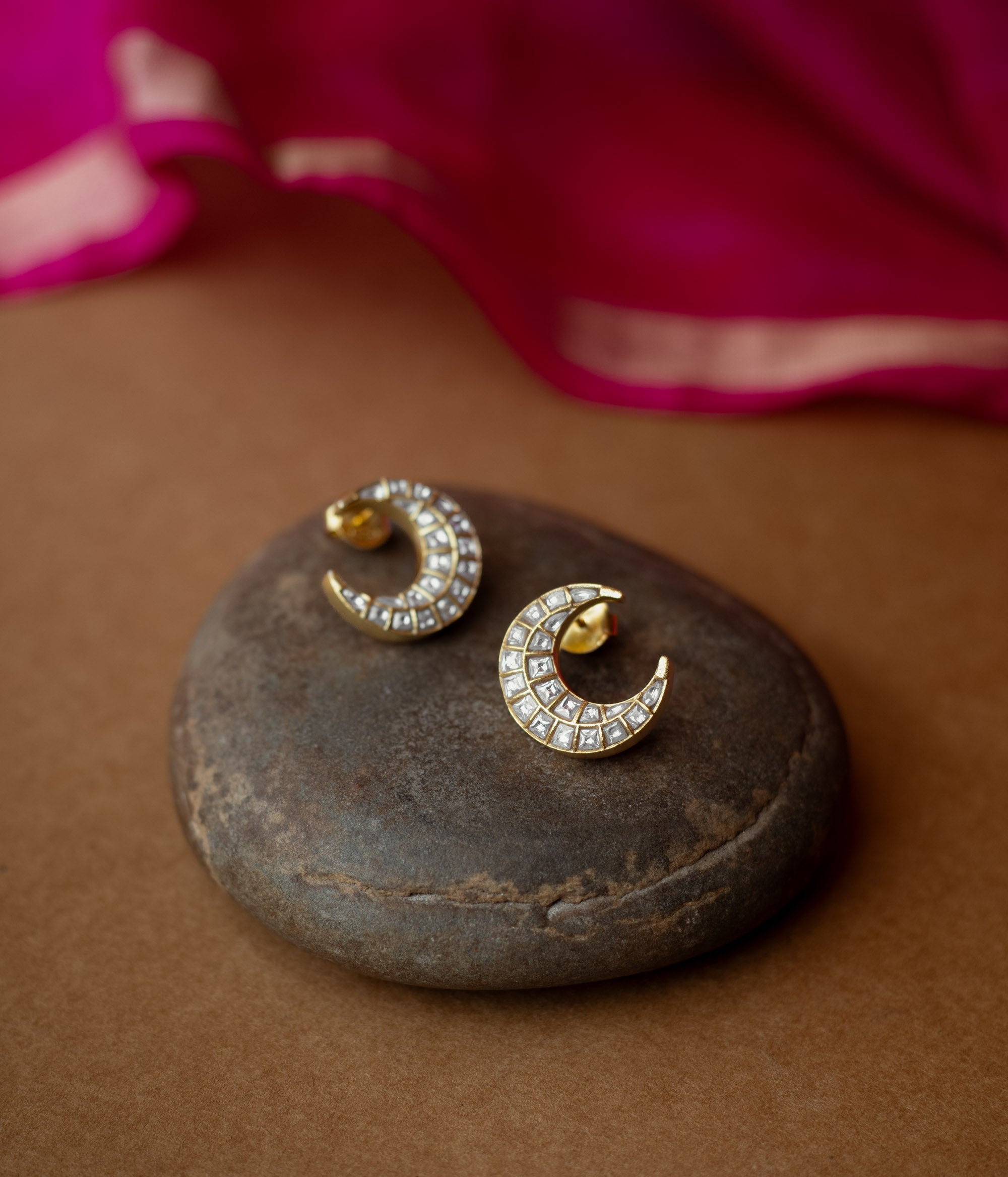 Gold crescent-shaped earrings studded with white Kundan stones from Kundan Collection, reflecting moonlight elegance.