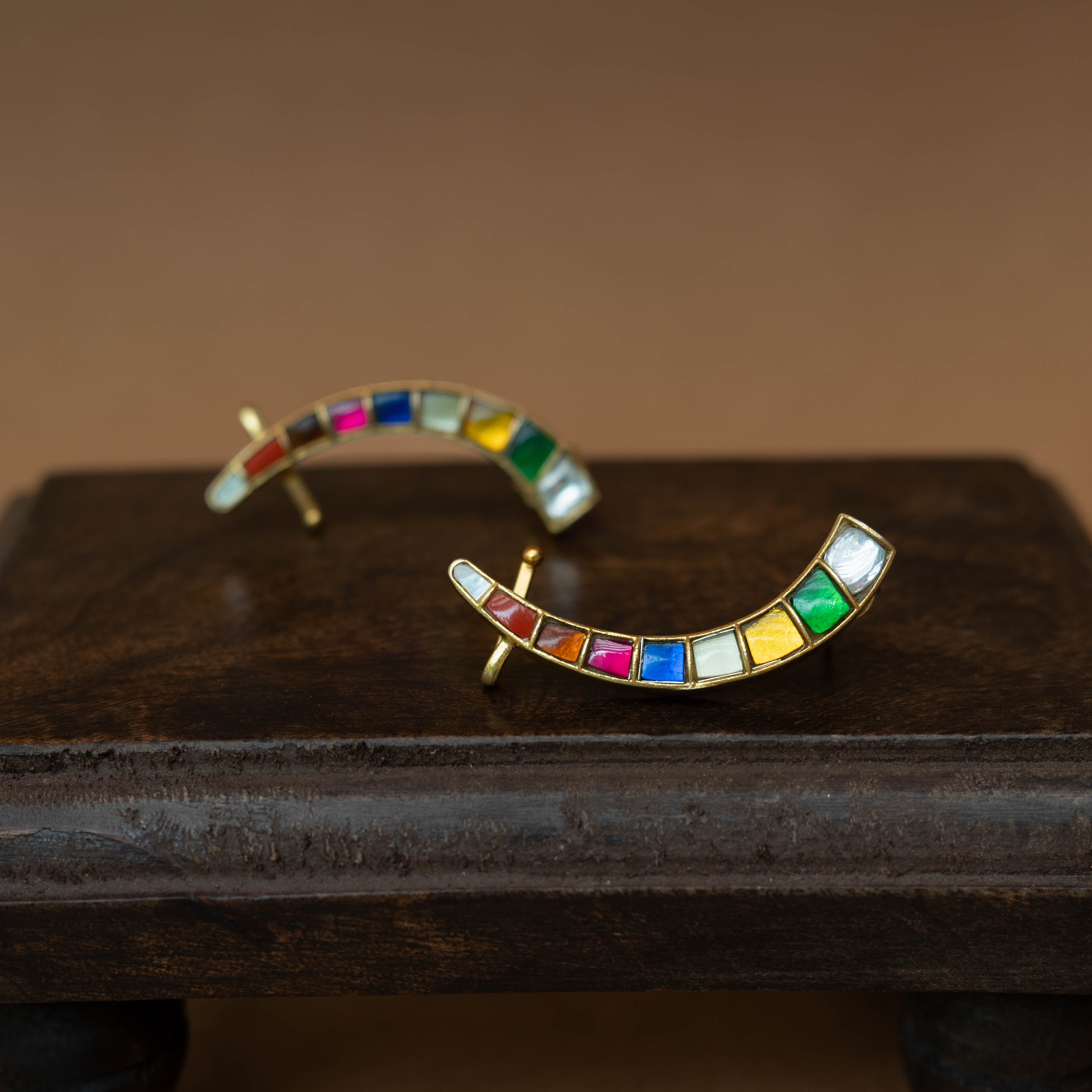 Curved ear crawlers with a row of multi-colored square stones.
