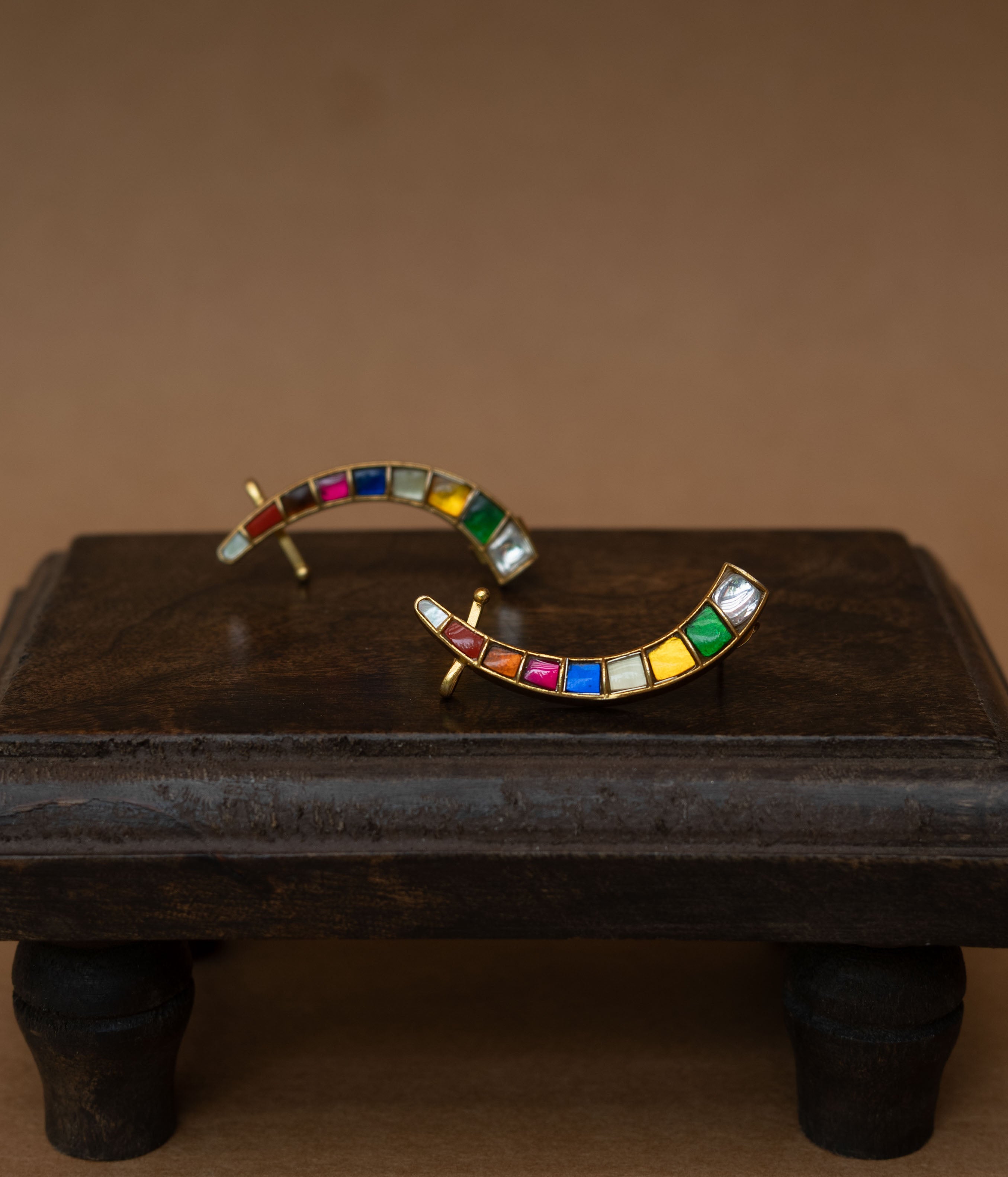 Curved ear crawlers with a row of multi-colored square stones.