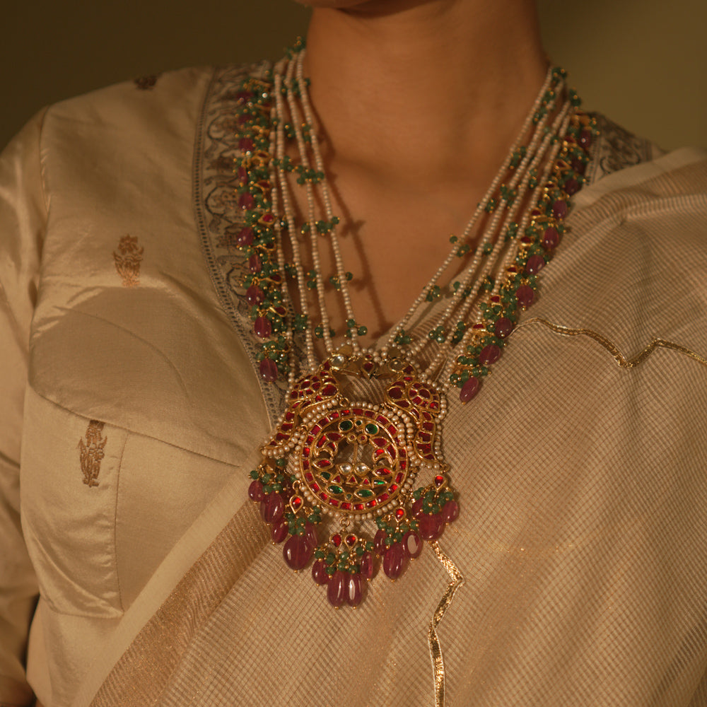 Garden-inspired necklace with pink-green Kundan and pearls—nature’s beauty woven into fine jewelry.