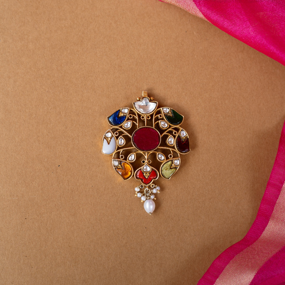 A round Kundan pendant with a central stone and dangling pearl drops.