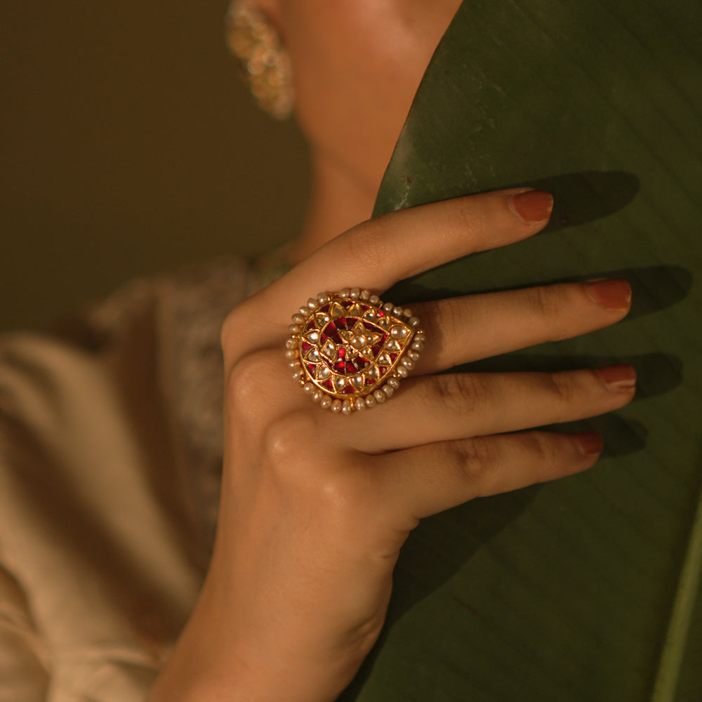 Floral-inspired Kundan ring with pearls—romantic and delicate, a miniature garden of gentle charm.