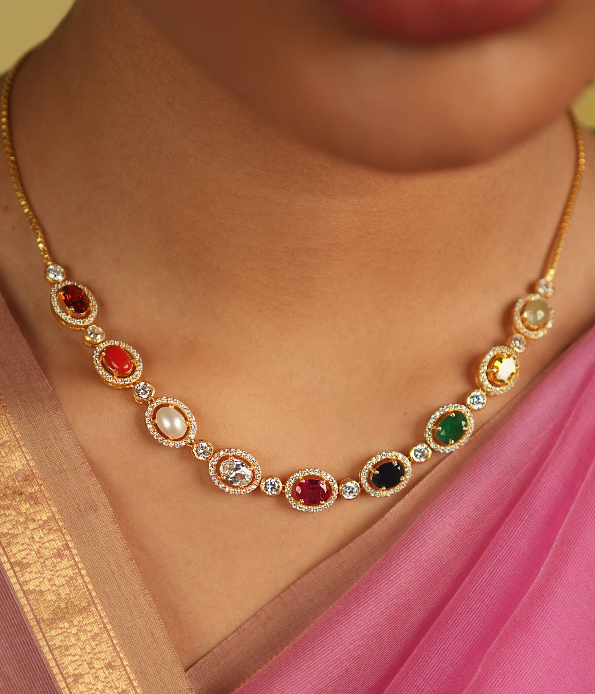 A sleek Navaratna necklace, adorned with shimmering Moissanites, radiates celestial grace and timeless charm.