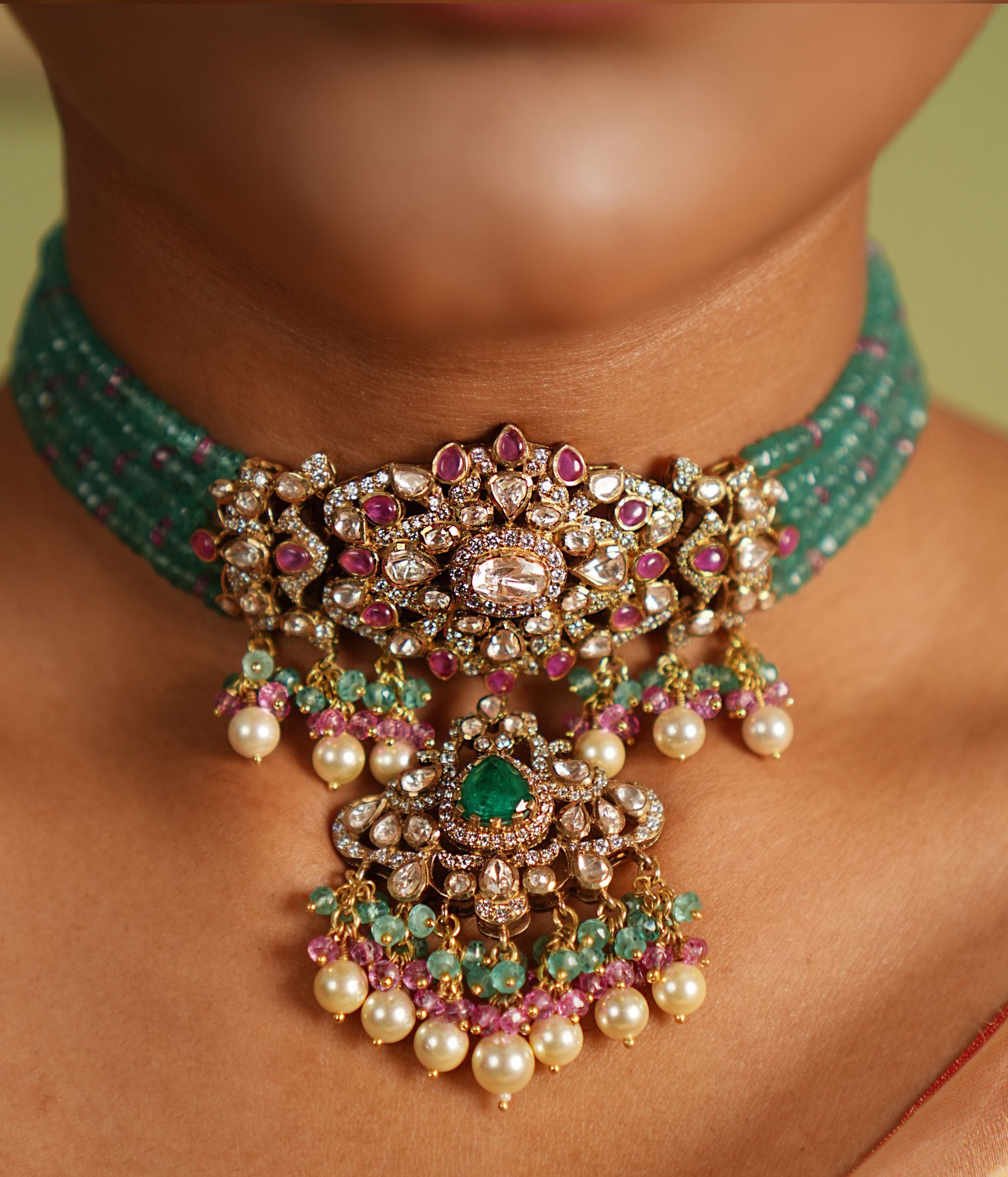 Stunning gold-plated silver choker featuring CZ stones, green jade, pink jade, moissanite Polki stones, and delicate pearls, crafted with an elegant and sophisticated design, perfect for any occasion.