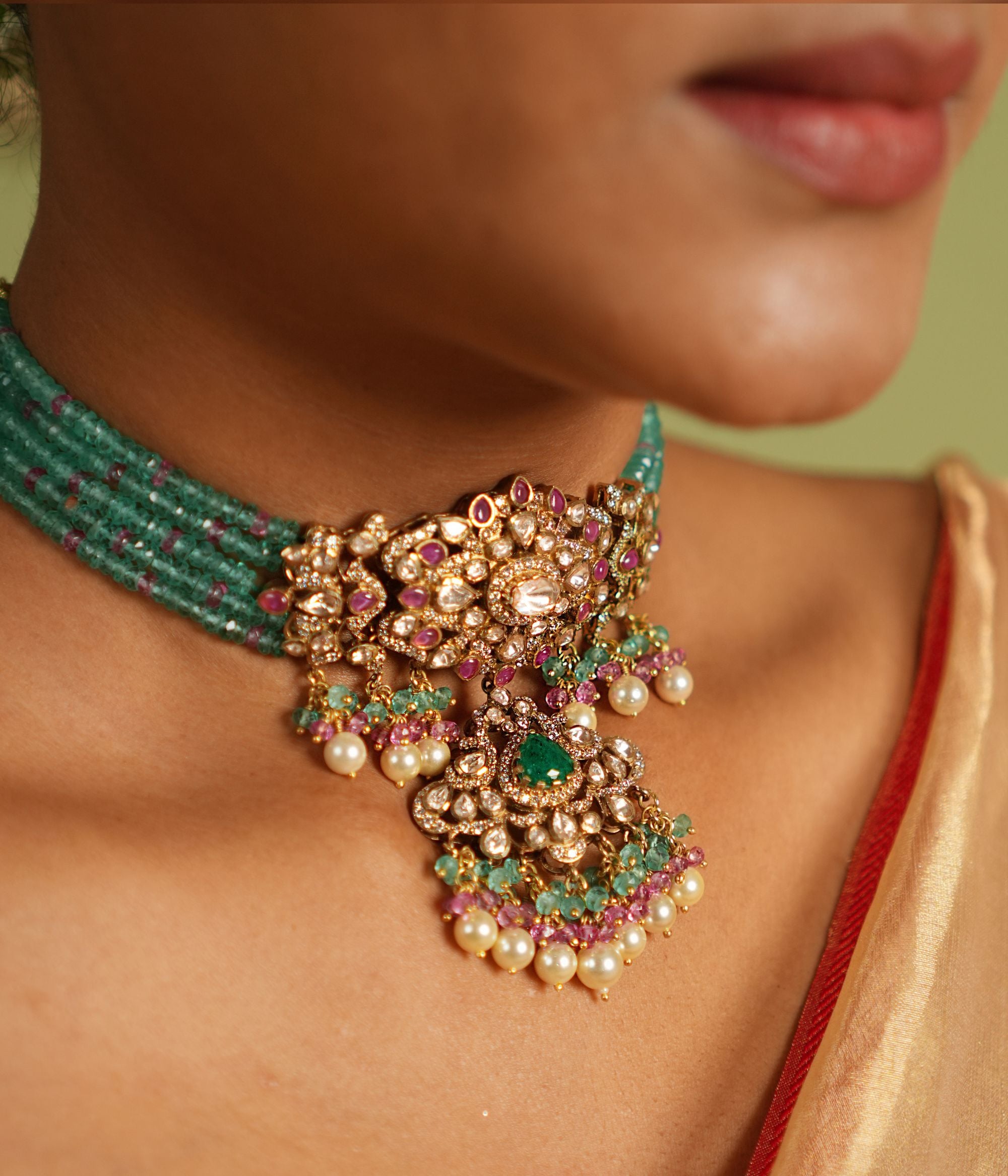 Stunning gold-plated silver choker featuring CZ stones, green jade, pink jade, moissanite Polki stones, and delicate pearls, crafted with an elegant and sophisticated design, perfect for any occasion.