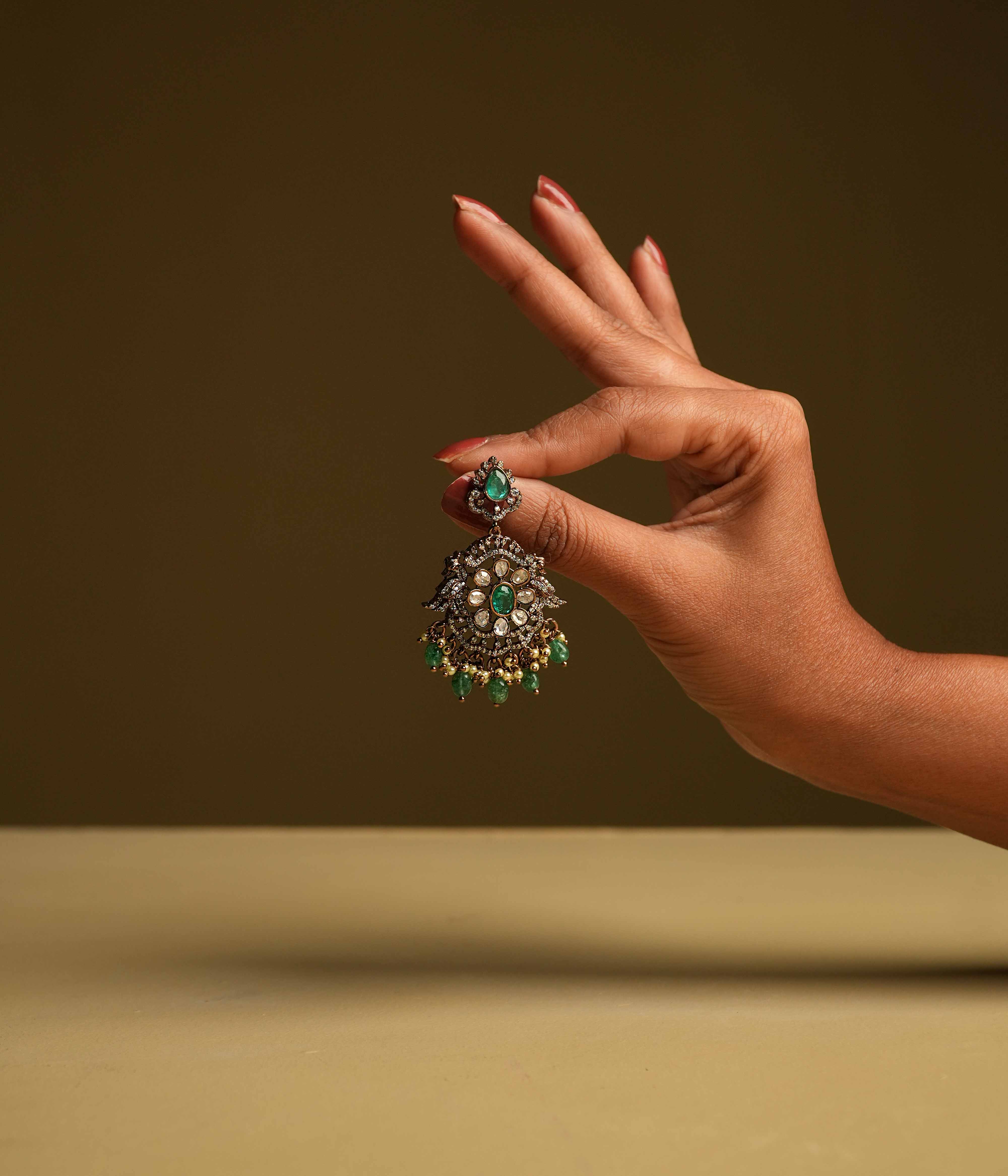 Royal Chandbali earrings, handcrafted from 92.5 sterling silver with 14ct dark antique gold plating and screw-type fastenings, featuring polki stones, CZ stones, green gemstones, and polki stones, with cultured emerald and pearl danglings evoking the opulence of a bygone era.