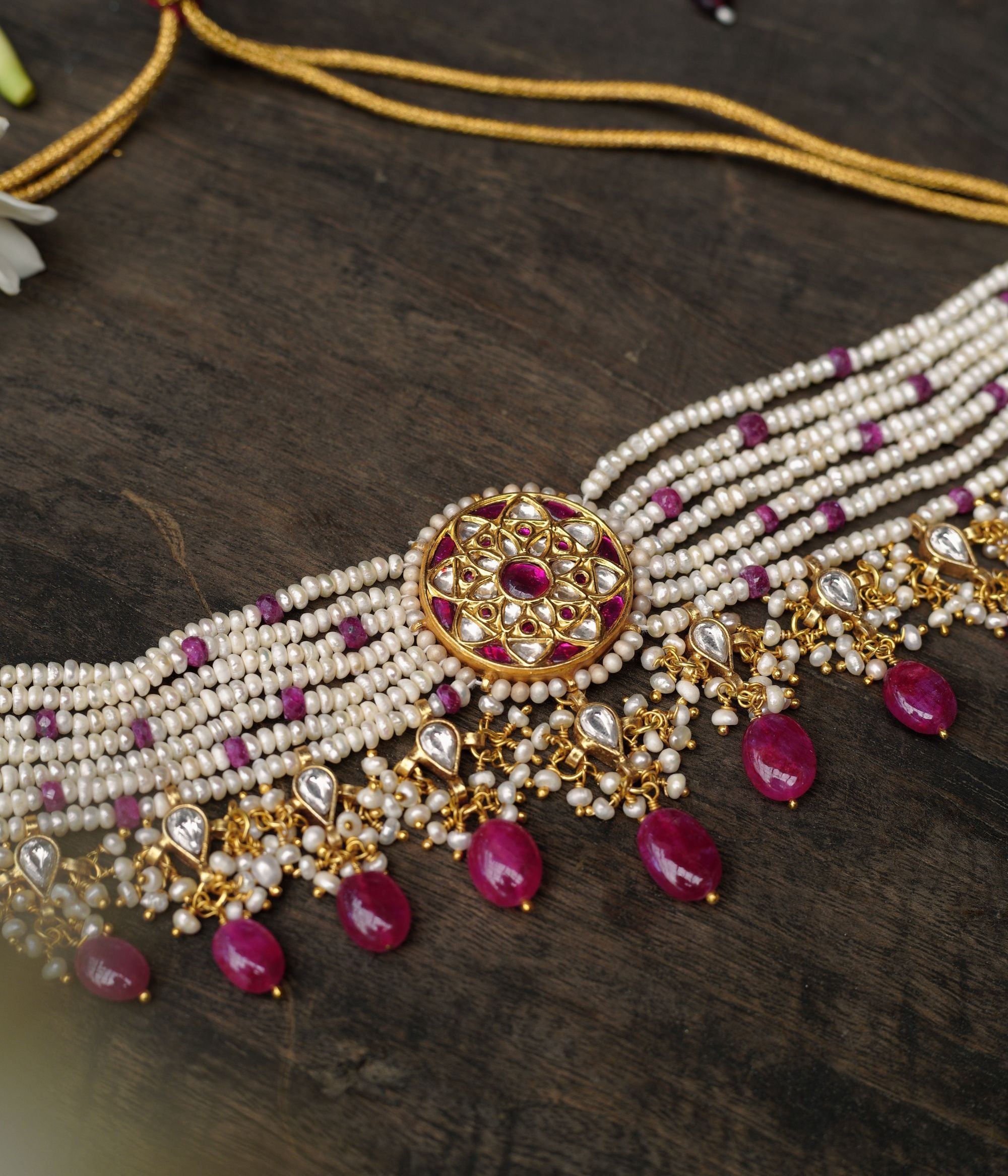 Gold choker with ruby medallion, pearl strands, white sapphires, and ruby drops from Leelah Collection.