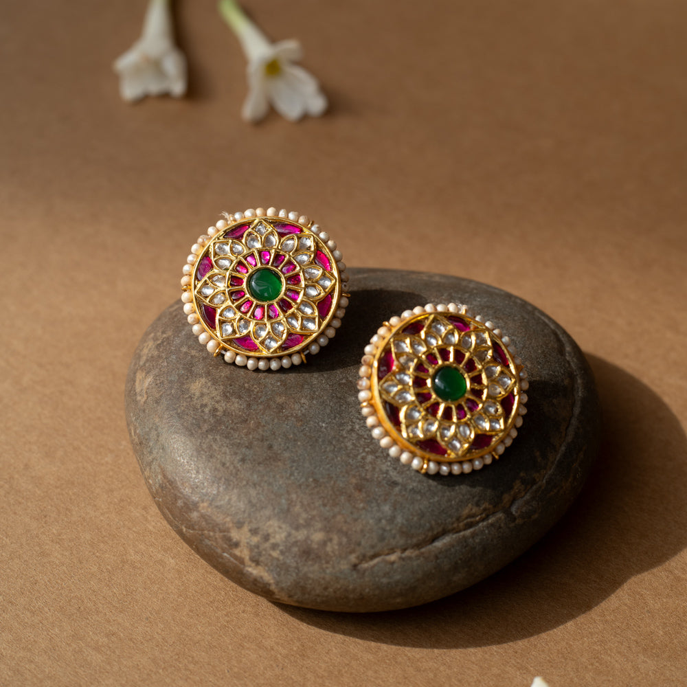 Round lotus-shaped earrings with rubies, white sapphires, pearl border, and green center from Leelah collection.