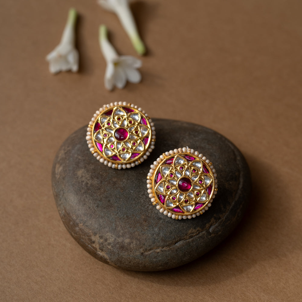 Round ruby-centered earrings with white sapphires and pearl edges in a mandala-style Leelah collection design.