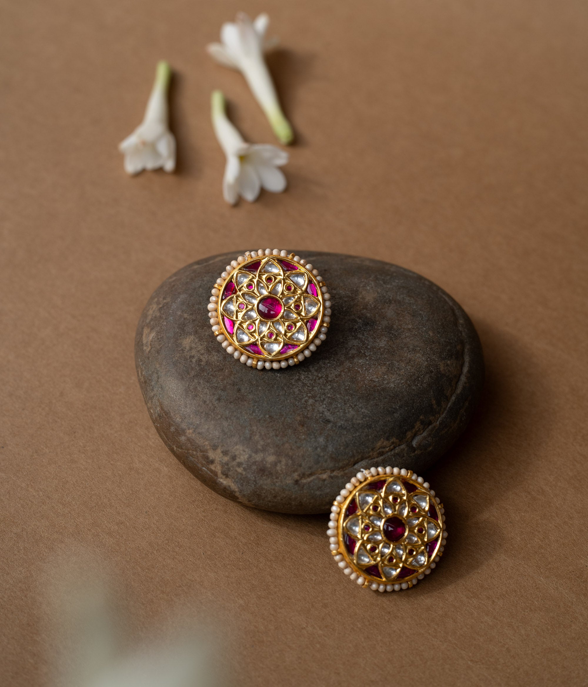 Round ruby-centered earrings with white sapphires and pearl edges in a mandala-style Leelah collection design.