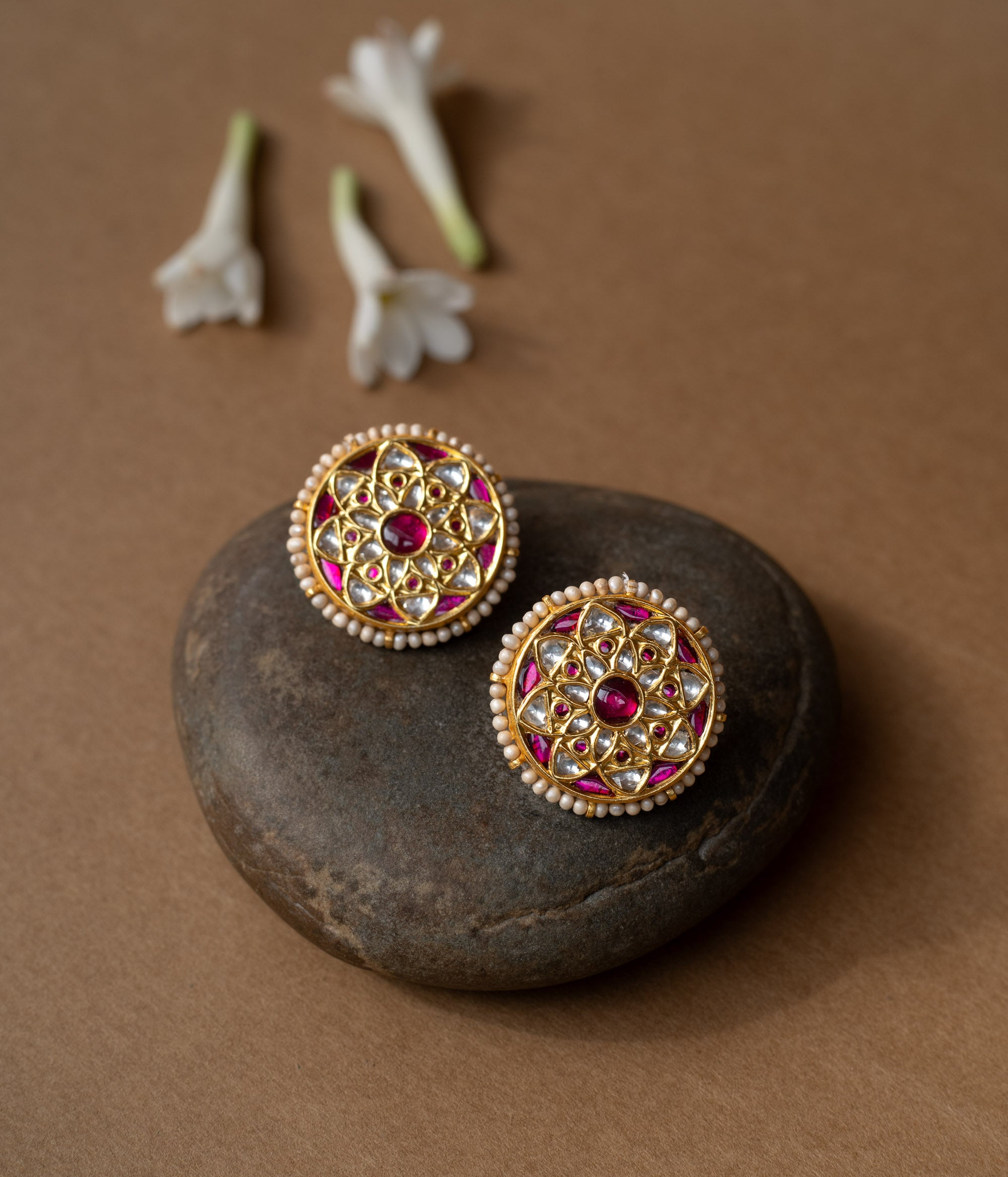 Round ruby-centered earrings with white sapphires and pearl edges in a mandala-style Leelah collection design.
