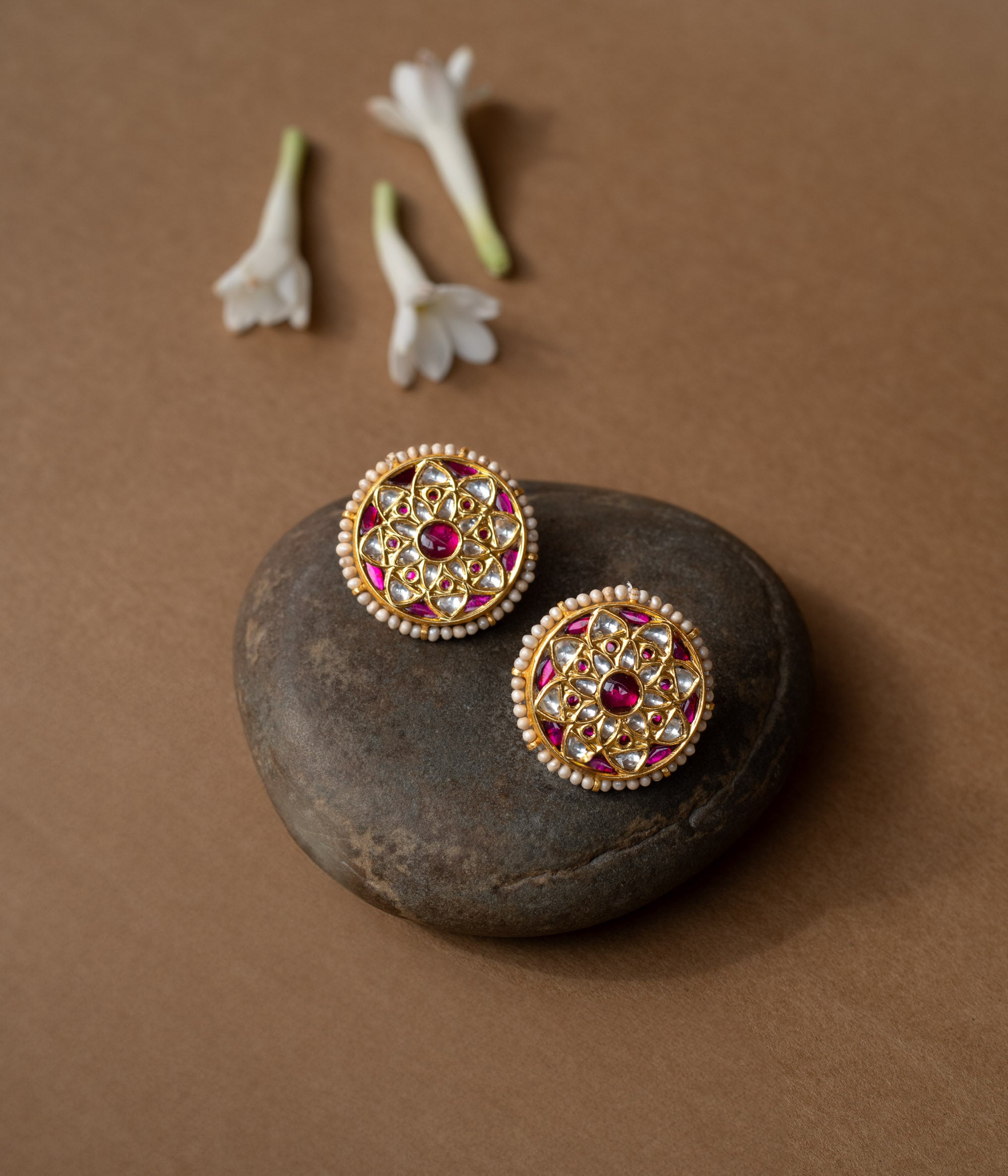 Round ruby-centered earrings with white sapphires and pearl edges in a mandala-style Leelah collection design.