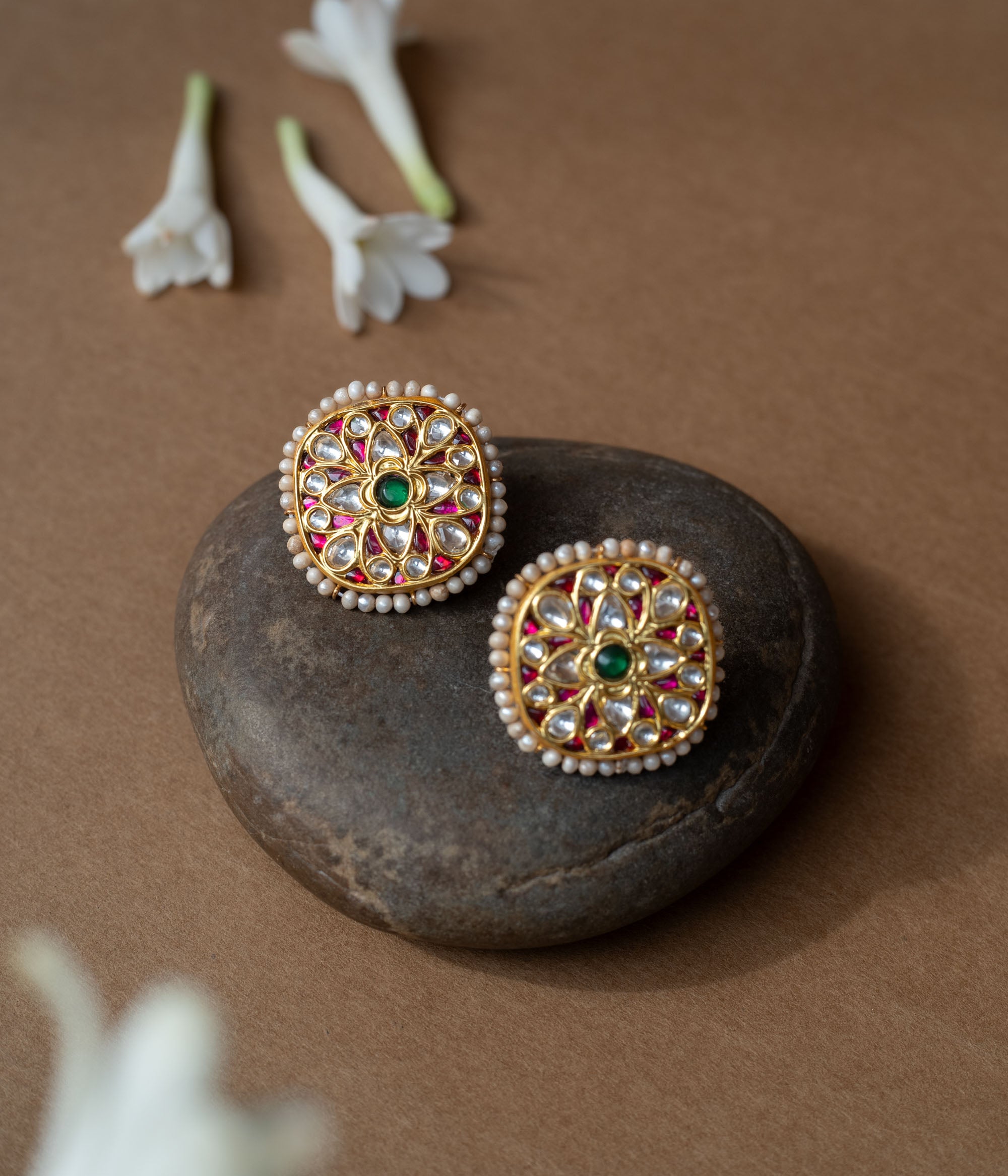 Square gold earrings with ruby, white sapphire petal motifs and a green center from Leelah collection.