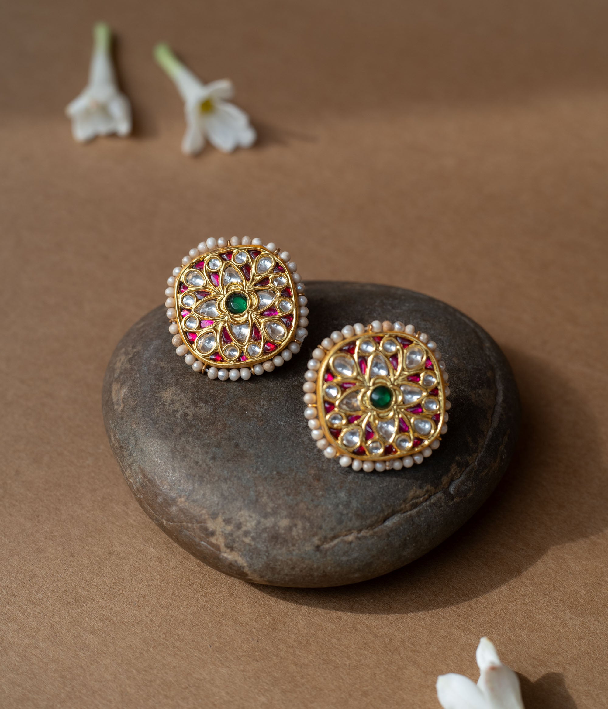 Square gold earrings with ruby, white sapphire petal motifs and a green center from Leelah collection.