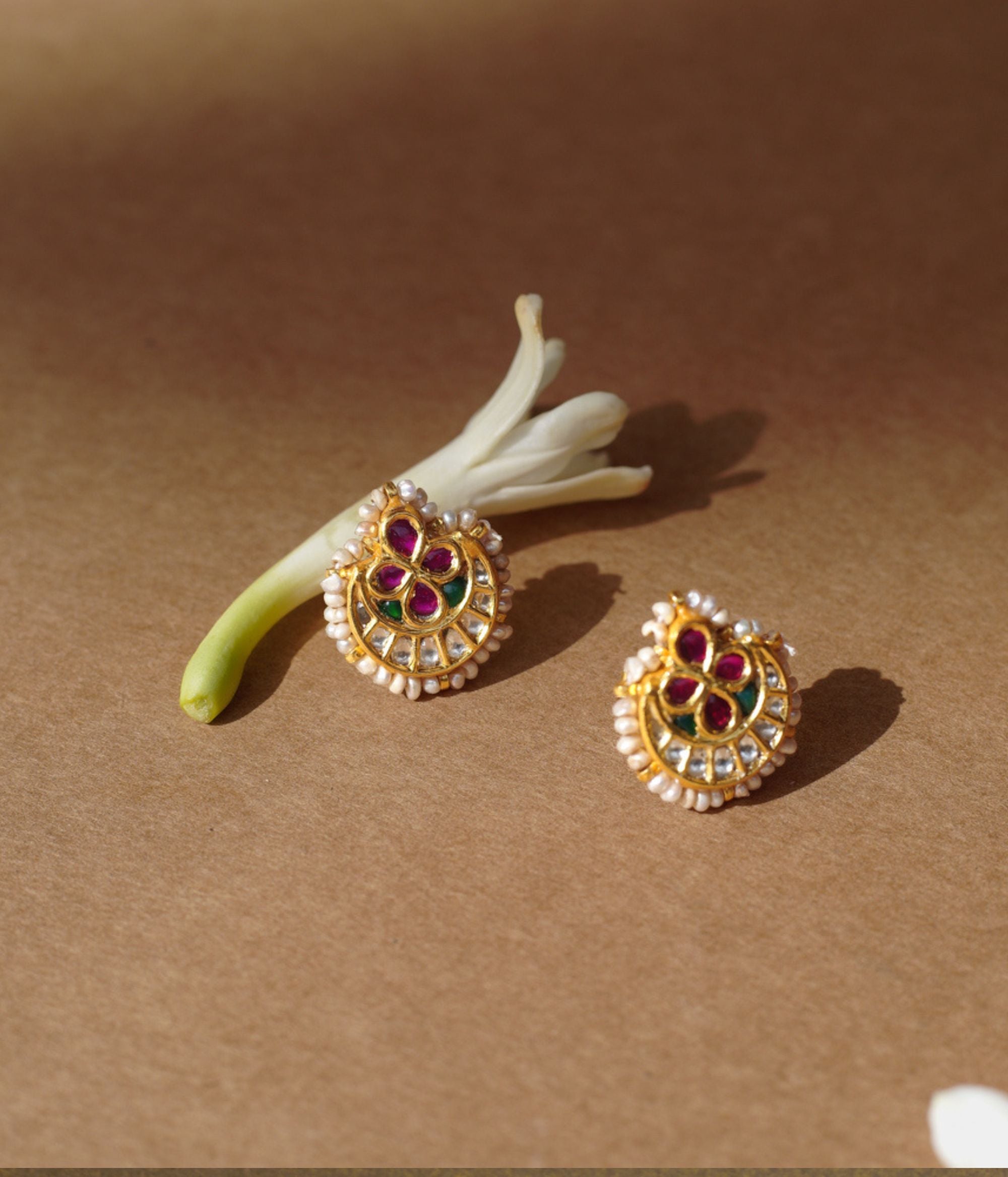 Gold earrings with ruby floral center, white sapphires, pearls, and green enamel from Leelah Collection.