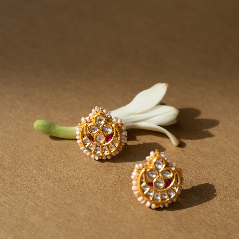 Teardrop-shaped gold earrings with white sapphires, rubies, and a pearl-studded edge.