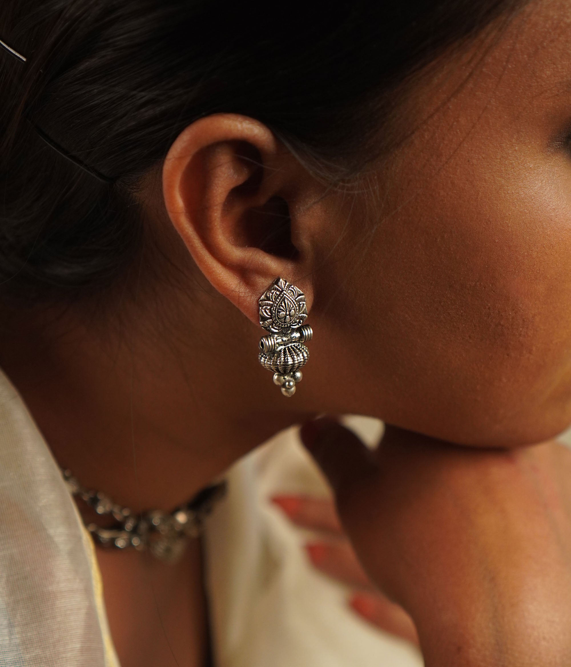 The Laya earrings, designed in oxidized silver, showcase intricate motifs that blend heritage craftsmanship with contemporary elegance—a timeless classic with a modern edge.