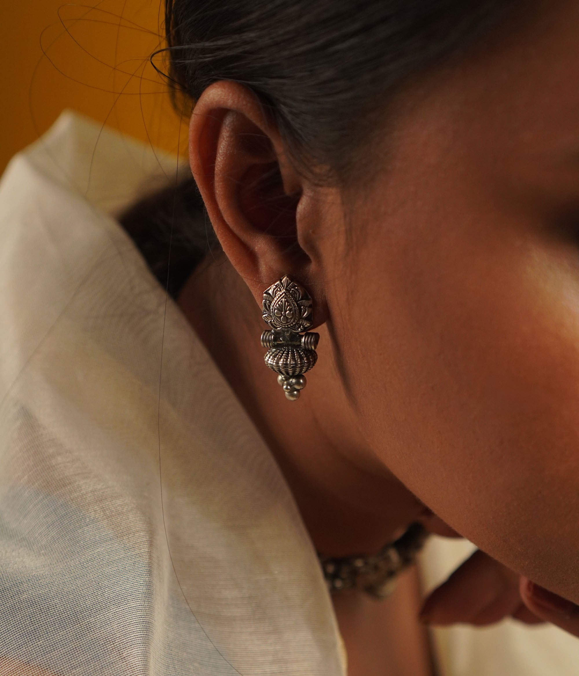 The Laya earrings, designed in oxidized silver, showcase intricate motifs that blend heritage craftsmanship with contemporary elegance—a timeless classic with a modern edge.