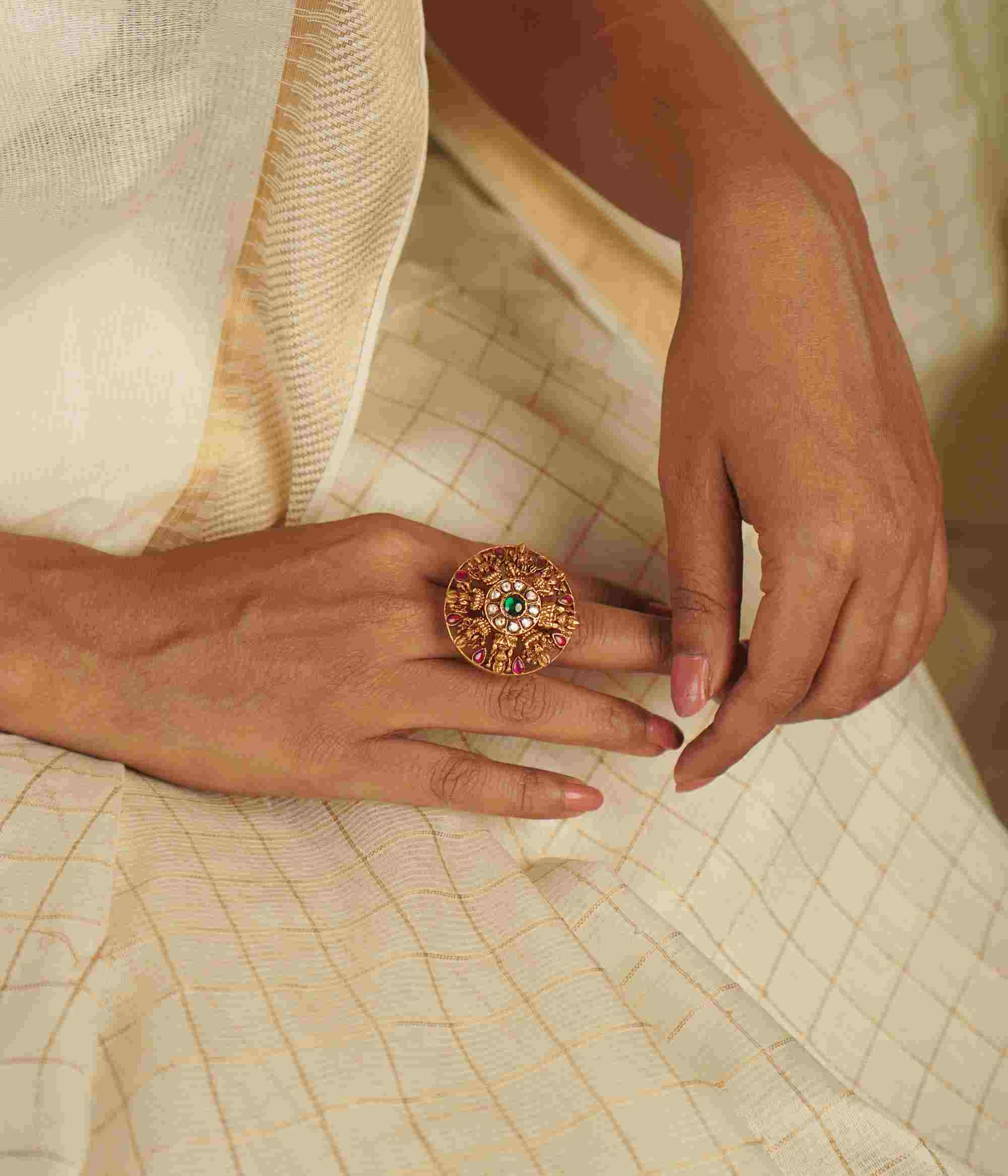 The Lochana Ring: A relic of the past, reborn. Gold-plated silver with temple-inspired motifs and radiant kundans, exuding vintage elegance with a modern charm.