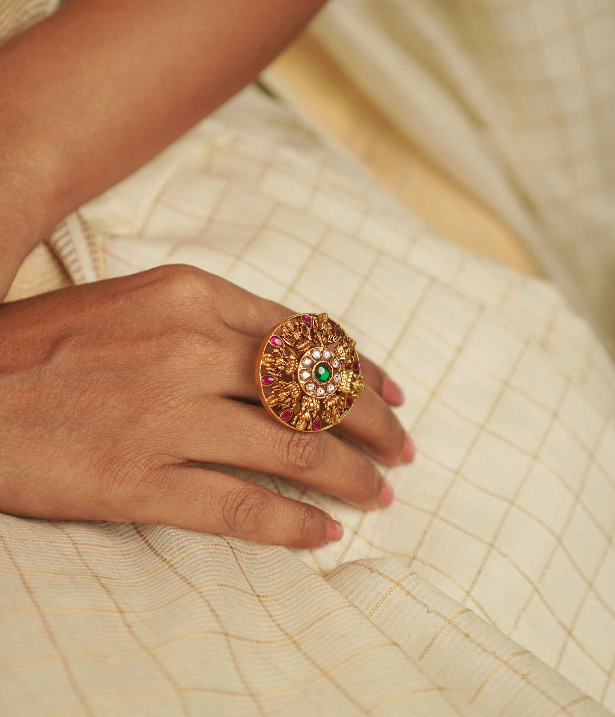 The Lochana Ring: A relic of the past, reborn. Gold-plated silver with temple-inspired motifs and radiant kundans, exuding vintage elegance with a modern charm.