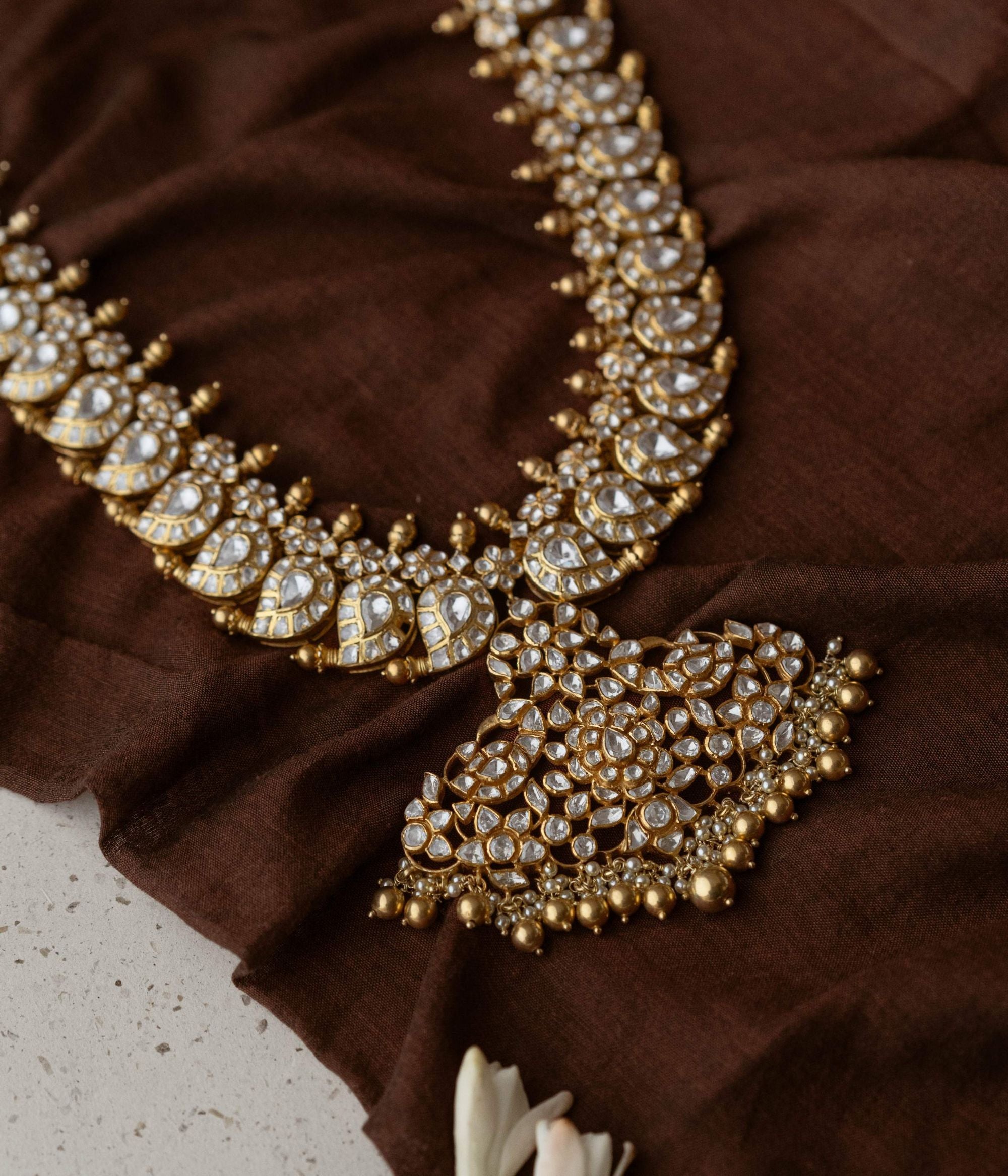 A necklace of enchantment, Woven with Polki Stones , it crowns its wearer in regal splendor.