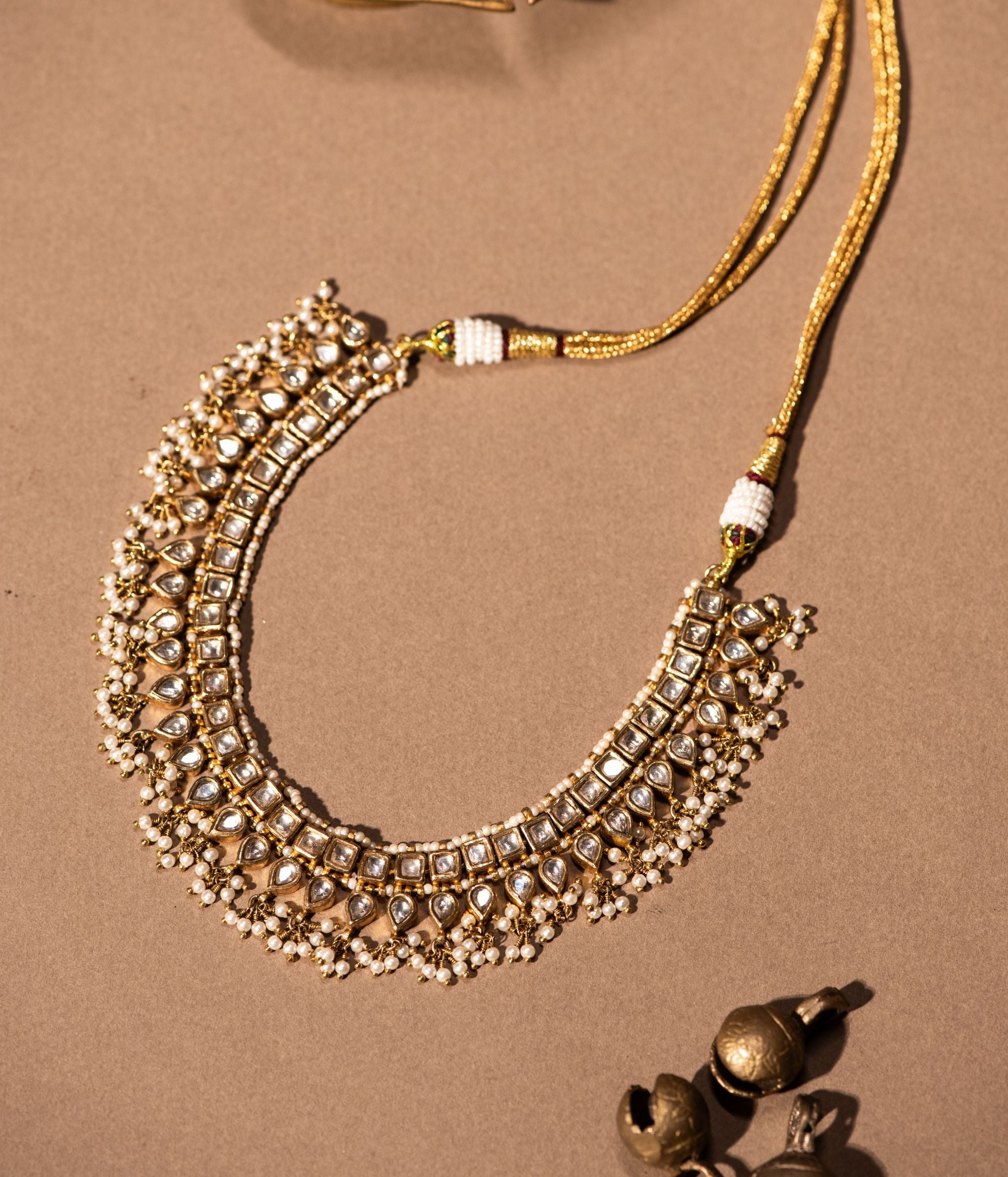 Gold-plated silver necklace adorned with shimmering white sapphires and elegant white pearl drops, designed to exude sophistication and grace, perfect for enhancing any special occasion attire.