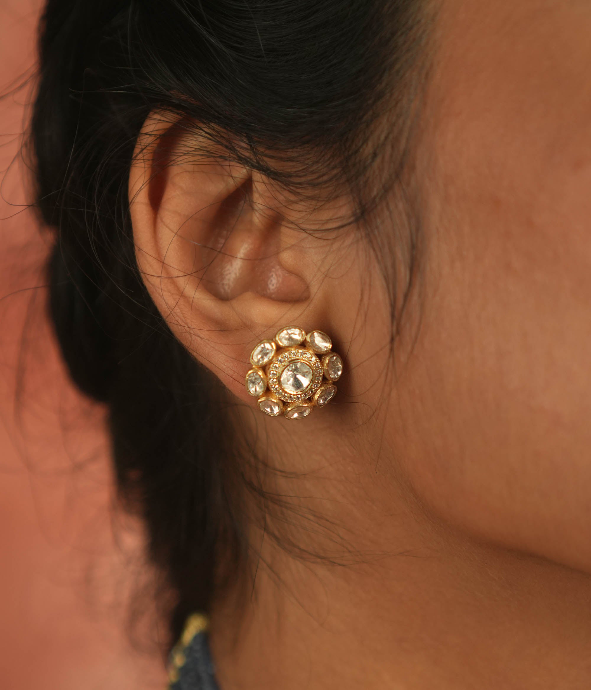 Artistry redefined! These round polki stud earrings, set in gold-plated silver, shimmer with moissanite brilliance, capturing nature's timeless charm.