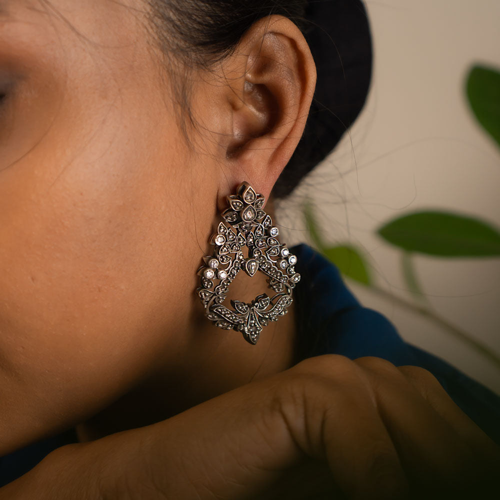 These oxidized Chandbali earrings, adorned with radiant white kundan stones, embody our commitment to crafting timeless elegance—perfect for everyday grace and lasting charm.
