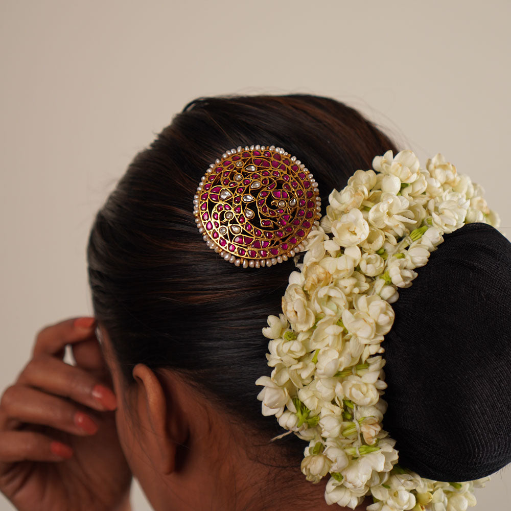 This hairpin beautifully blends red and white kundans with pearls, set in lustrous gold-polished silver. A timeless accessory that adds a touch of elegance and tradition.