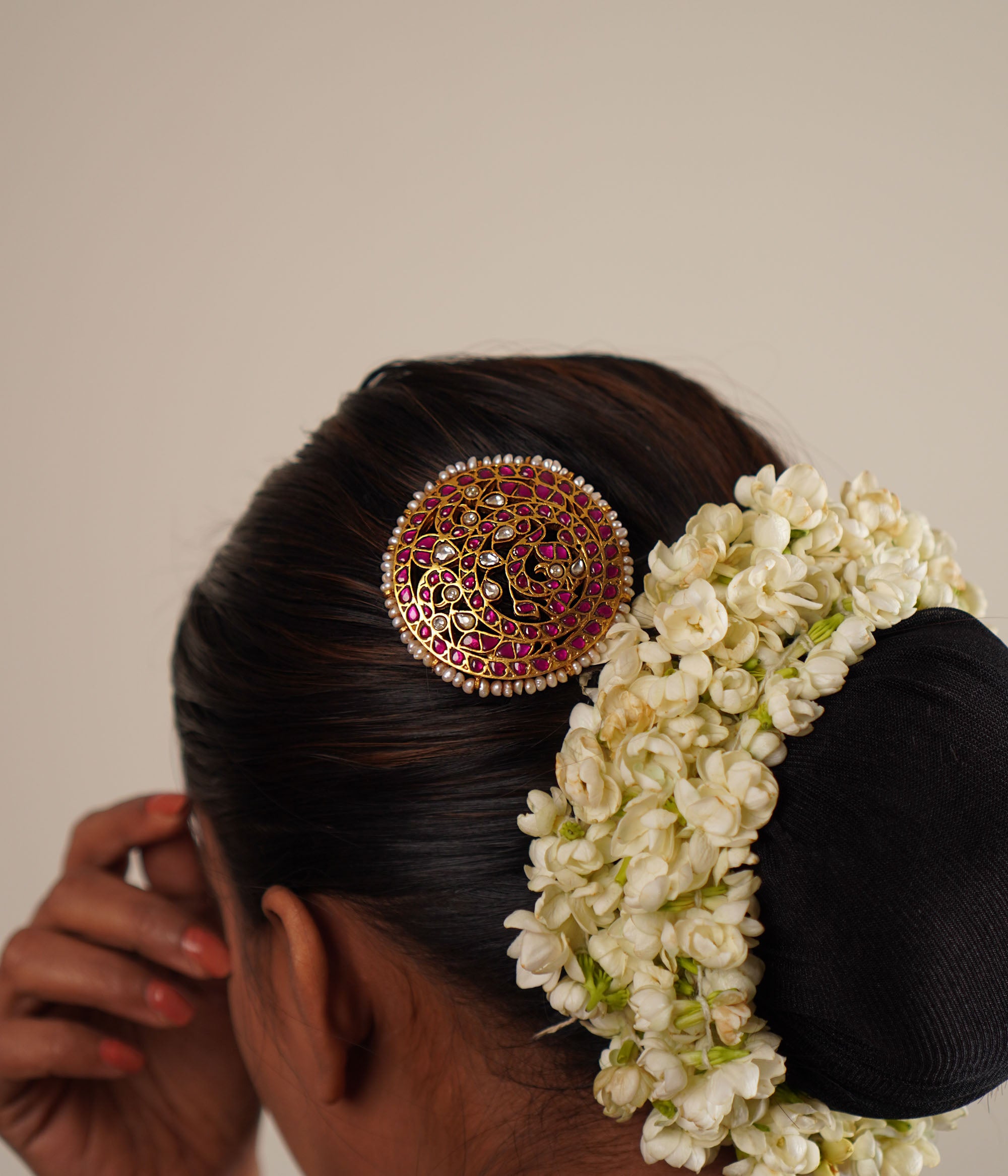 This hairpin beautifully blends red and white kundans with pearls, set in lustrous gold-polished silver. A timeless accessory that adds a touch of elegance and tradition.
