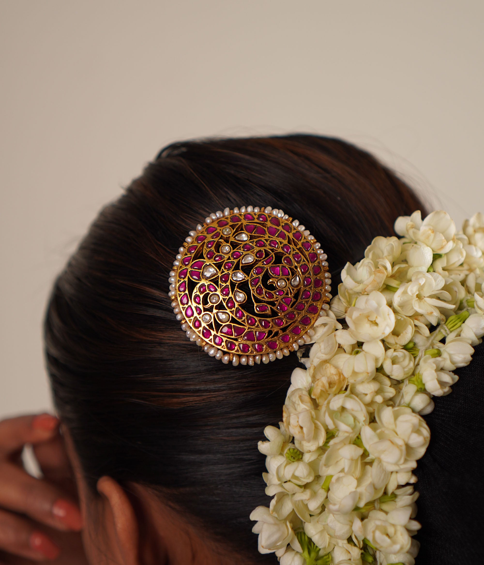 This hairpin beautifully blends red and white kundans with pearls, set in lustrous gold-polished silver. A timeless accessory that adds a touch of elegance and tradition.