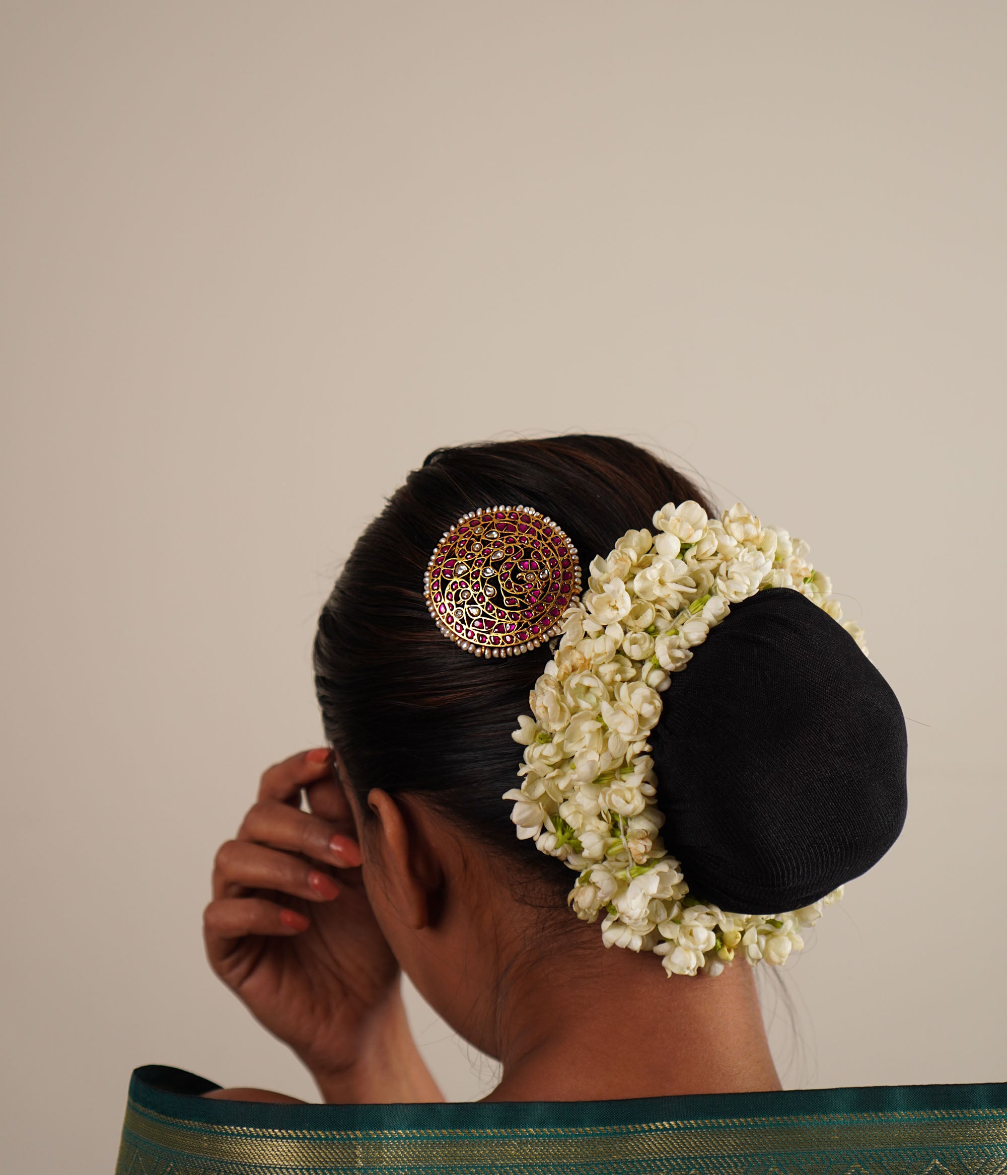 This hairpin beautifully blends red and white kundans with pearls, set in lustrous gold-polished silver. A timeless accessory that adds a touch of elegance and tradition.