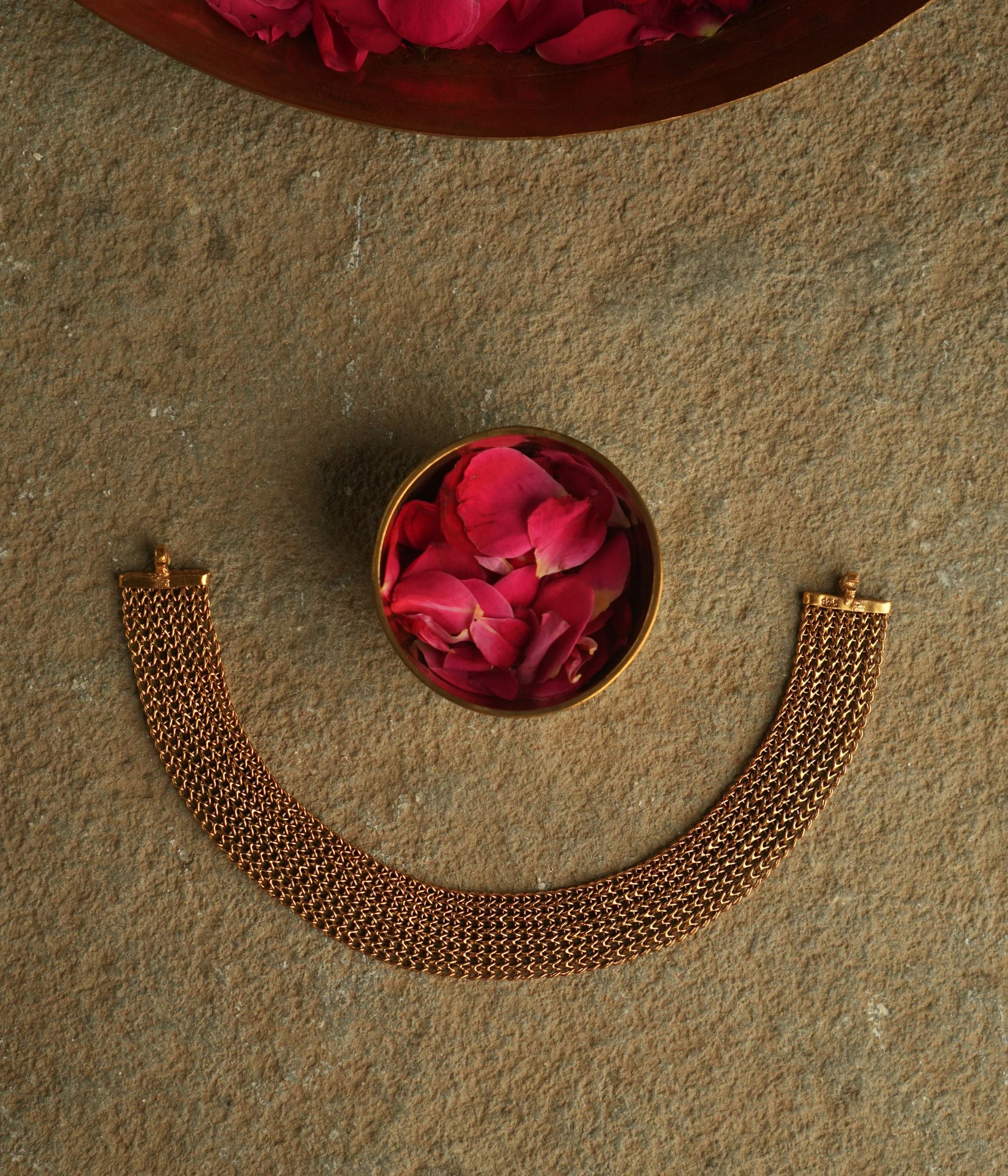 A vintage-inspired gold-plated silver mesh choker exudes an air of timeless sophistication, weaving stories of heritage and elegance.