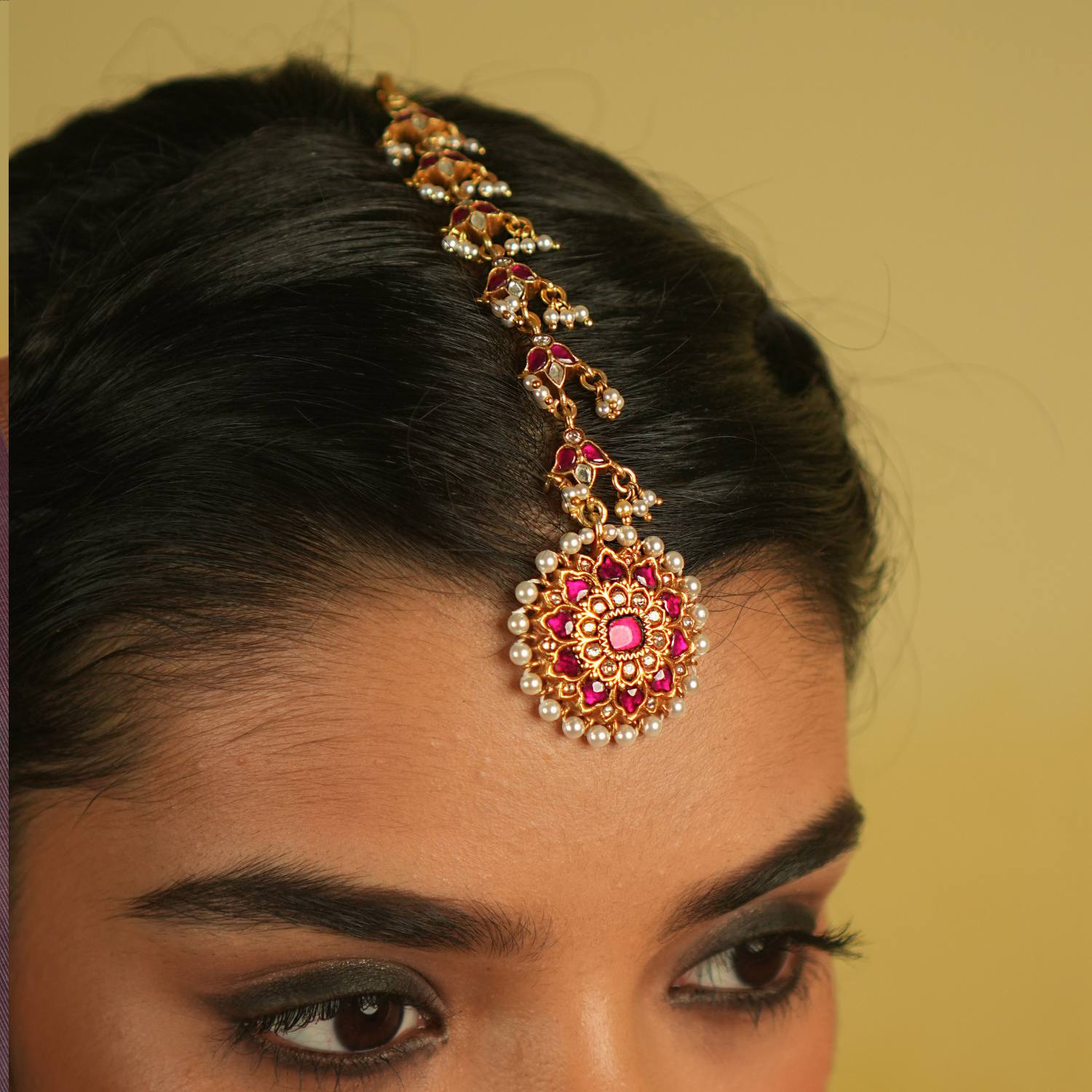 Embrace timeless tradition with our exquisite Kundan Tikka, adorned with radiant red and white Kundan stones, complemented by lustrous pearls. Its flawless craftsmanship exudes elegance, making it a perfect piece for any occasion.