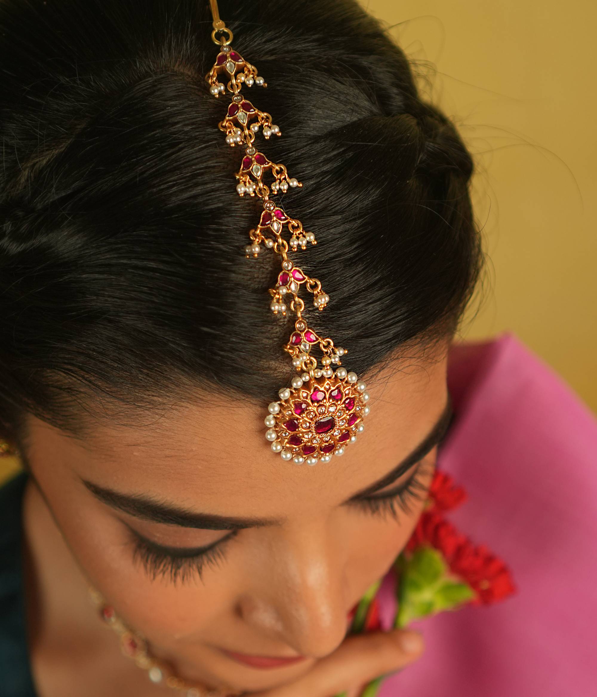 Embrace timeless tradition with our exquisite Kundan Tikka, adorned with radiant red and white Kundan stones, complemented by lustrous pearls. Its flawless craftsmanship exudes elegance, making it a perfect piece for any occasion.